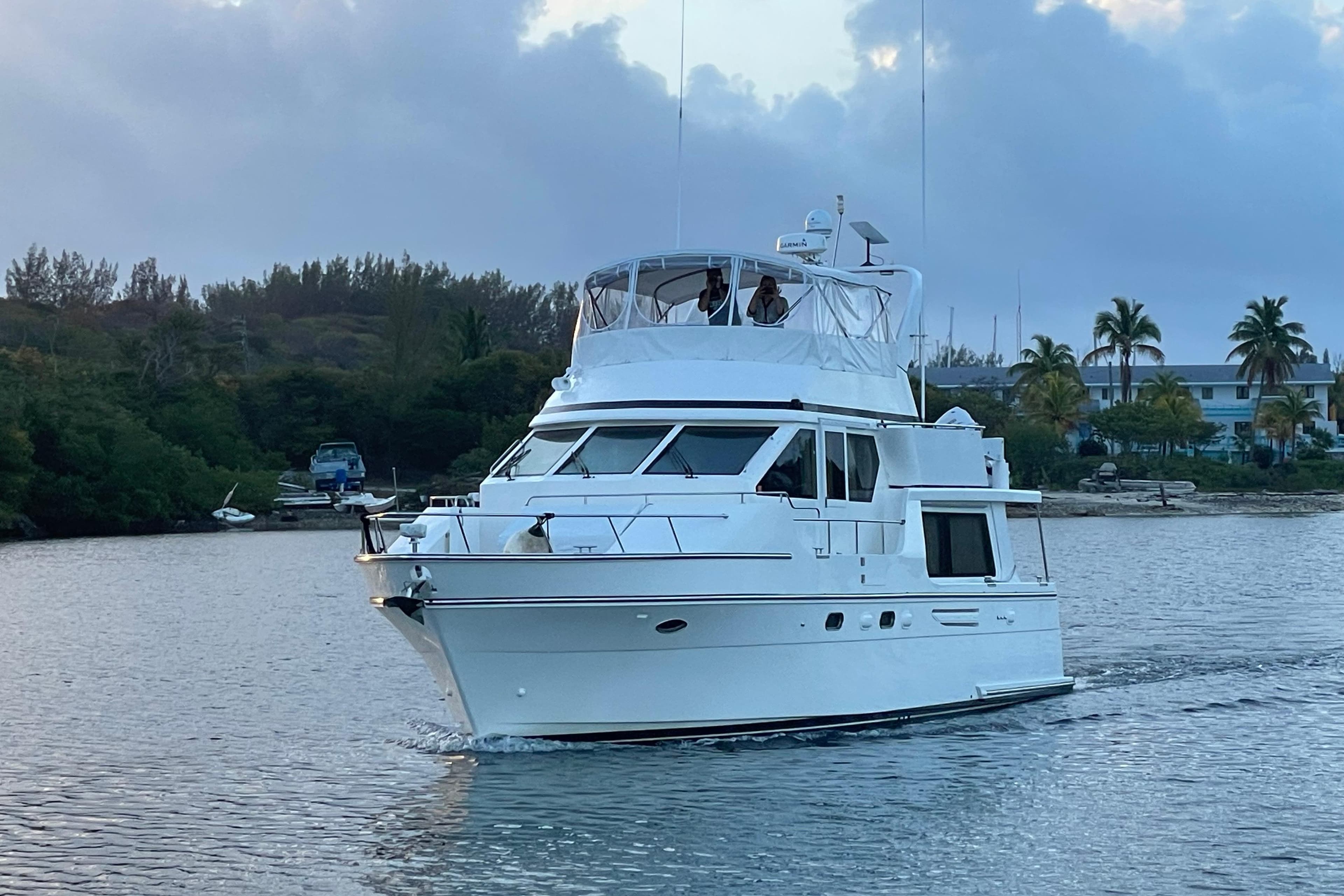 2007 Jefferson Pilothouse 52 SE yacht cruising on a serene waterway.