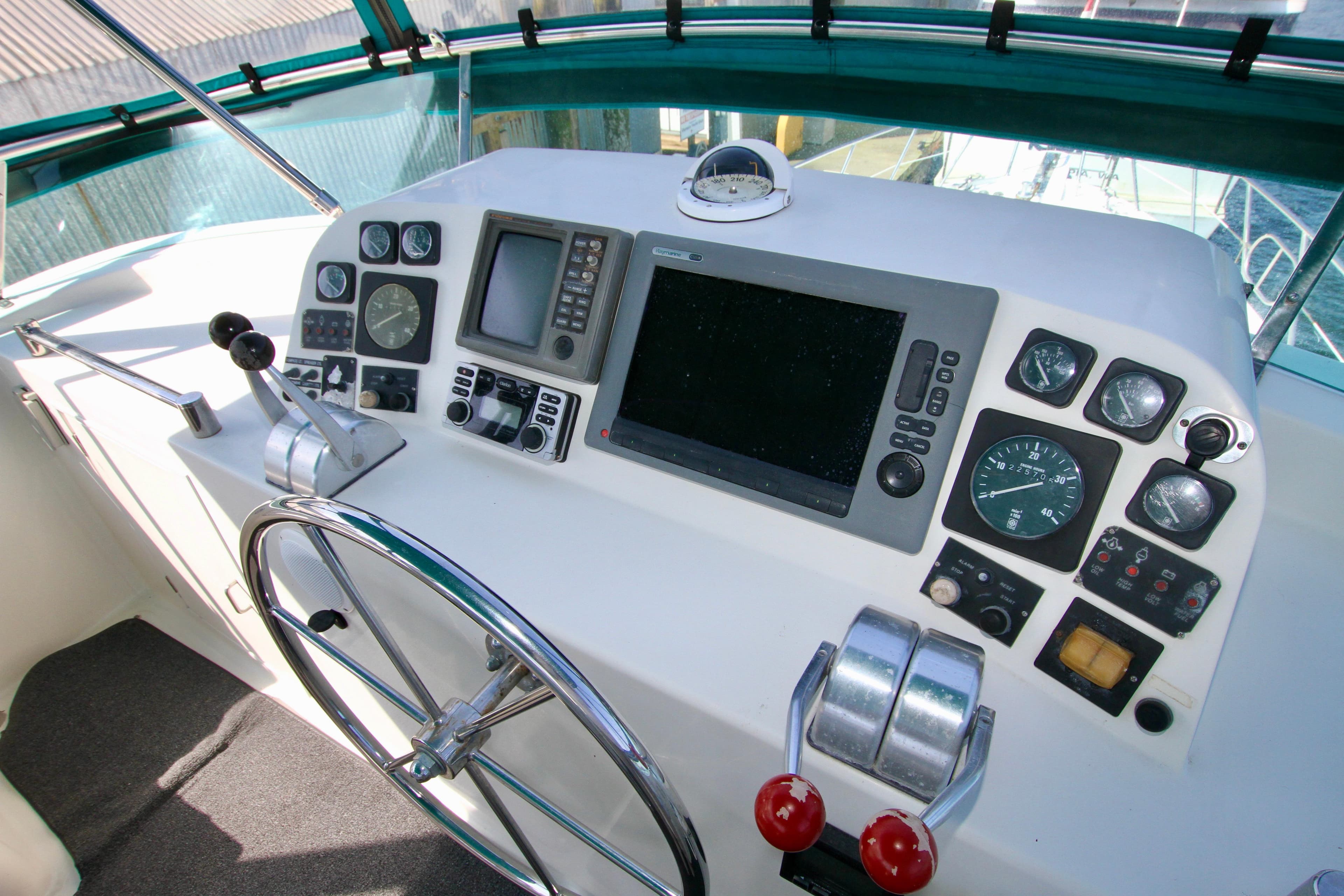 Control panel of a 1999 McKinna 47 Sedan yacht with navigation instruments.