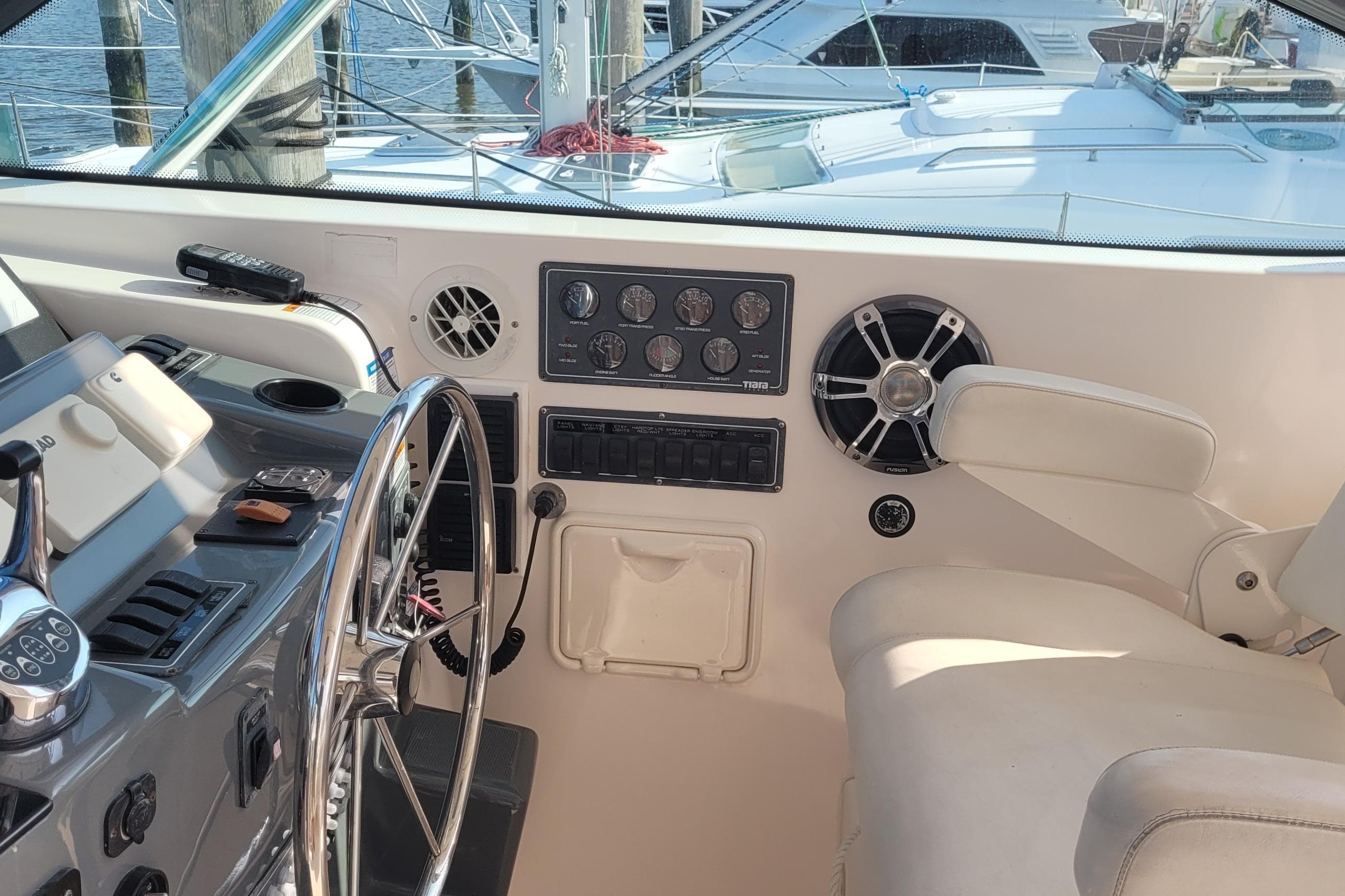 Helm of 2006 Tiara Yachts 4200 Open with steering wheel and control panel.
