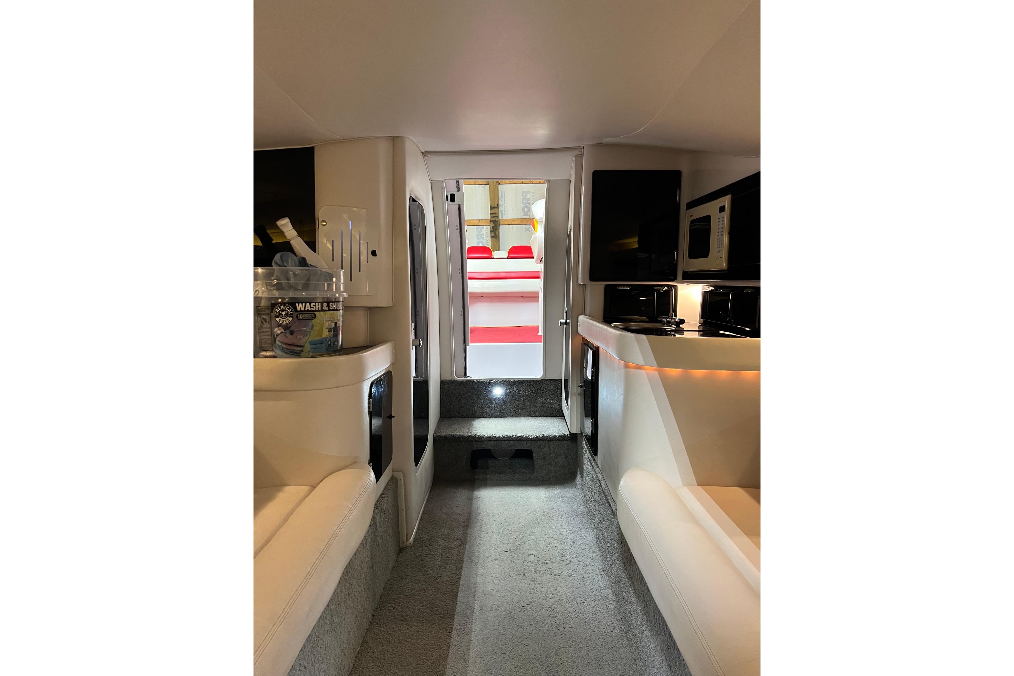 Interior of a 2002 Donzi 38 ZX boat, featuring seating and kitchenette.