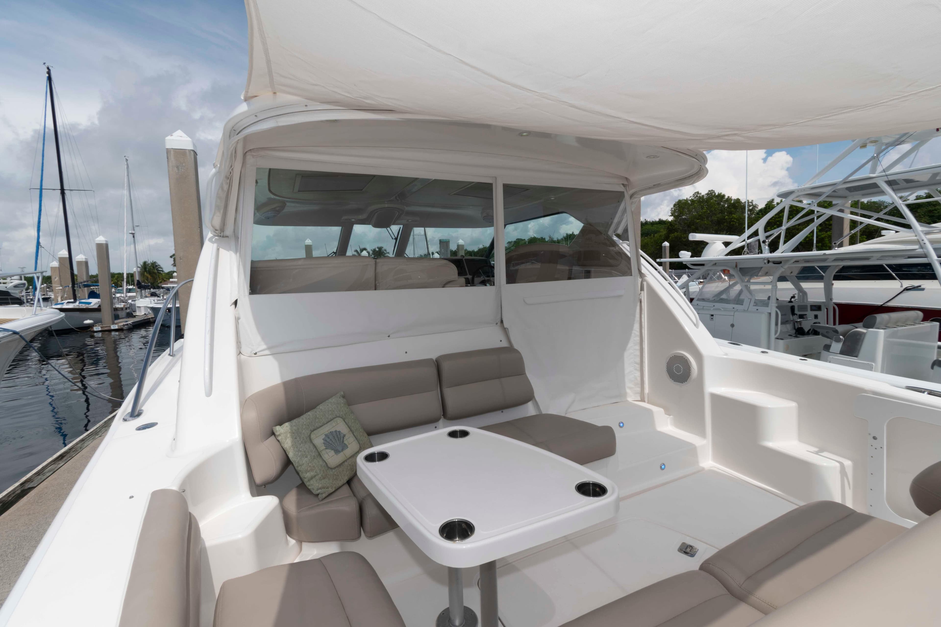 2007 Tiara Yachts 4300 Sovran with spacious seating and table in marina setting.