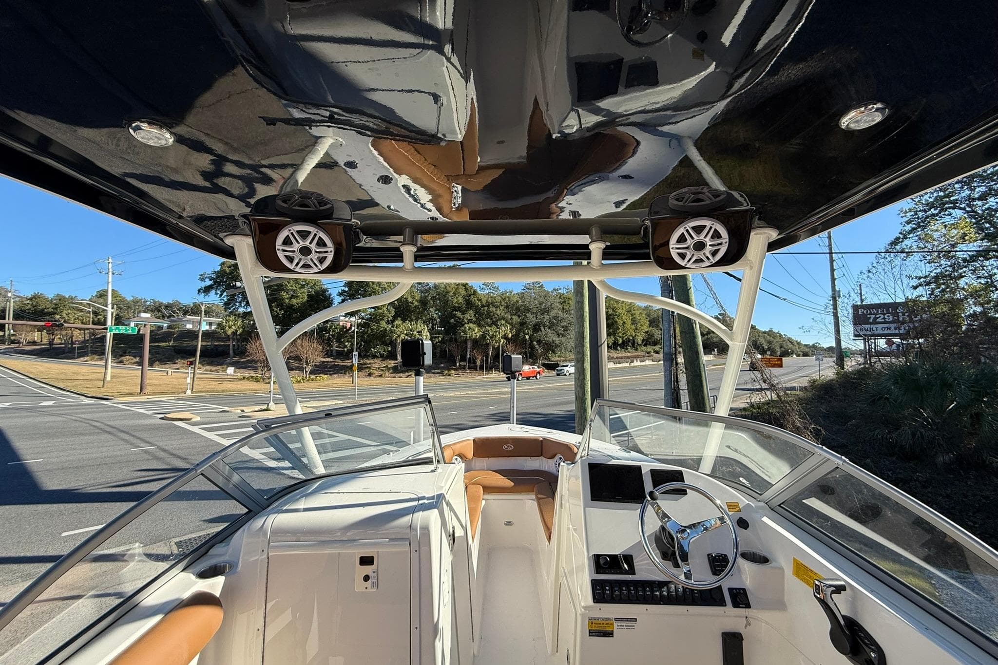 2026 Key West 239 DFS boat interior with steering wheel, dashboard, and road view.