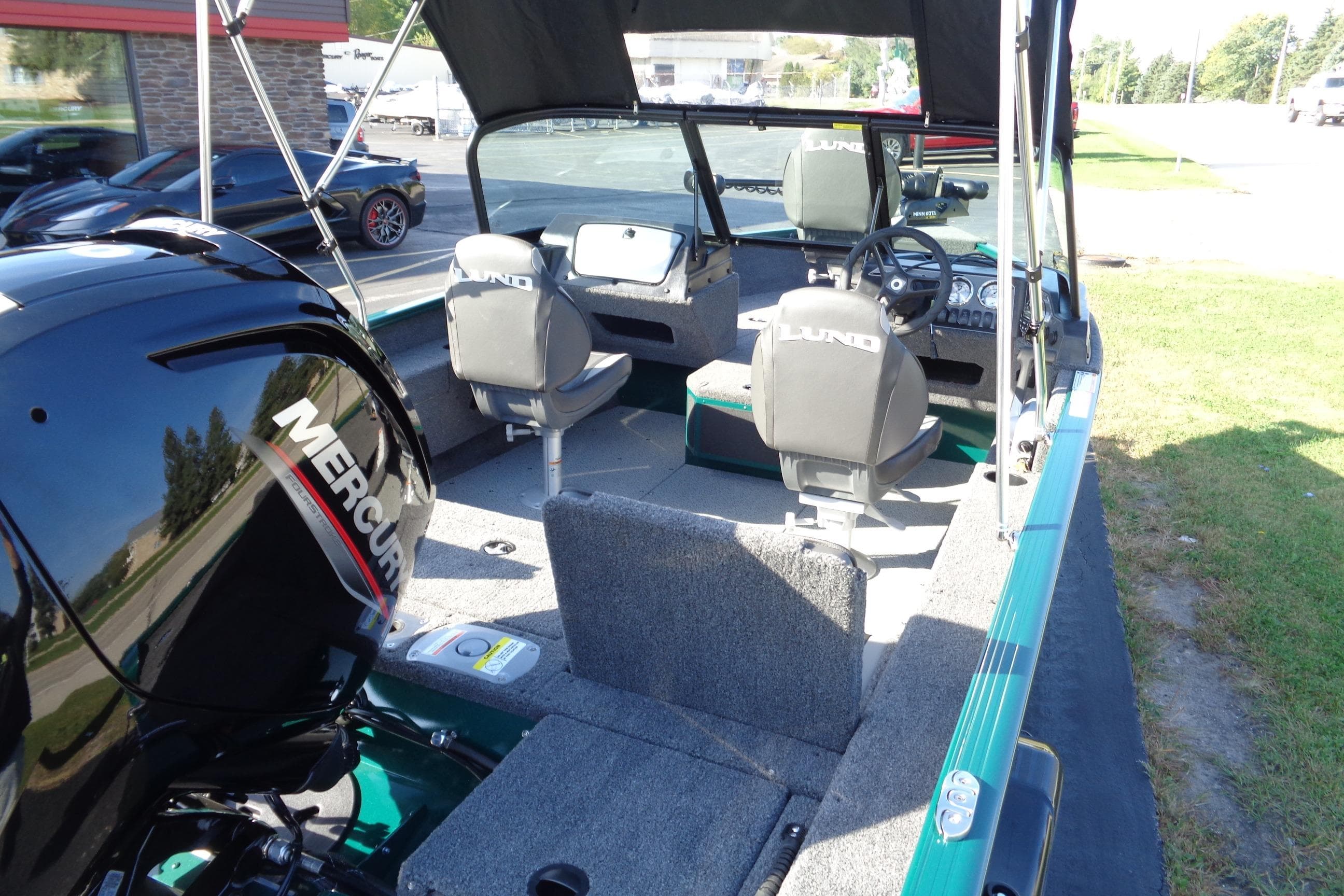 2026 Lund 1675 Adventure Sport boat interior with Mercury engine, featuring seating and steering console.