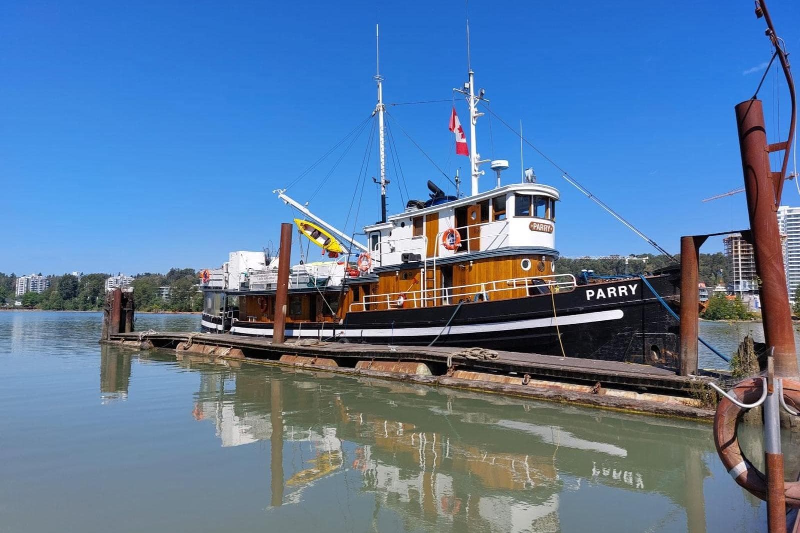 1941 Armstrong Marine Custom Wooden Trawler Charter Vessel docked on a sunny day.