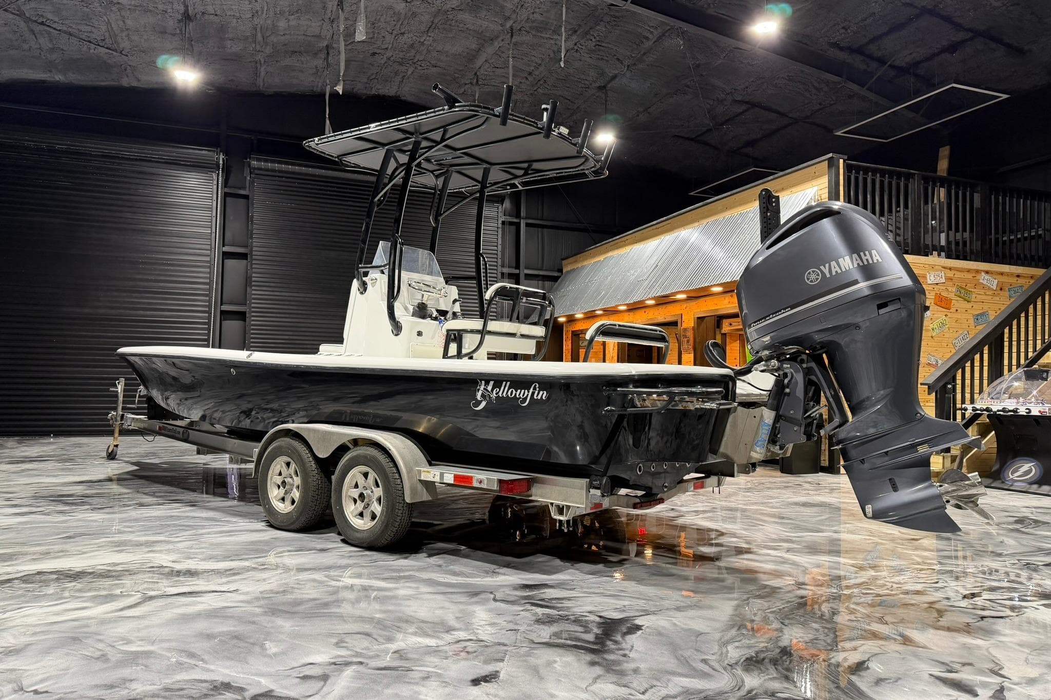 2011 Yellowfin 24 Bay boat with Yamaha engine on trailer in showroom.