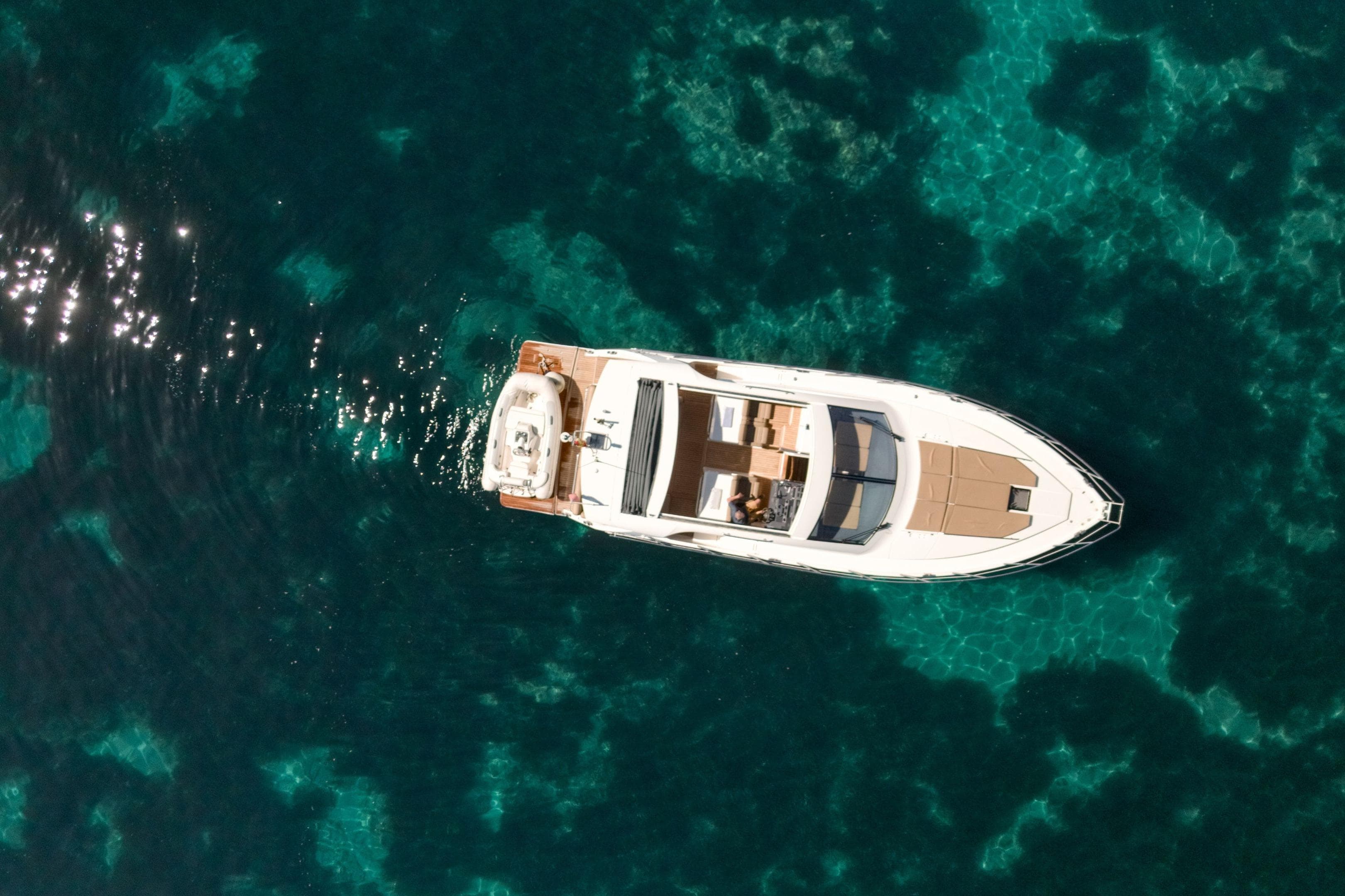 Aerial view of 2012 Sealine SC42 yacht on clear turquoise water.