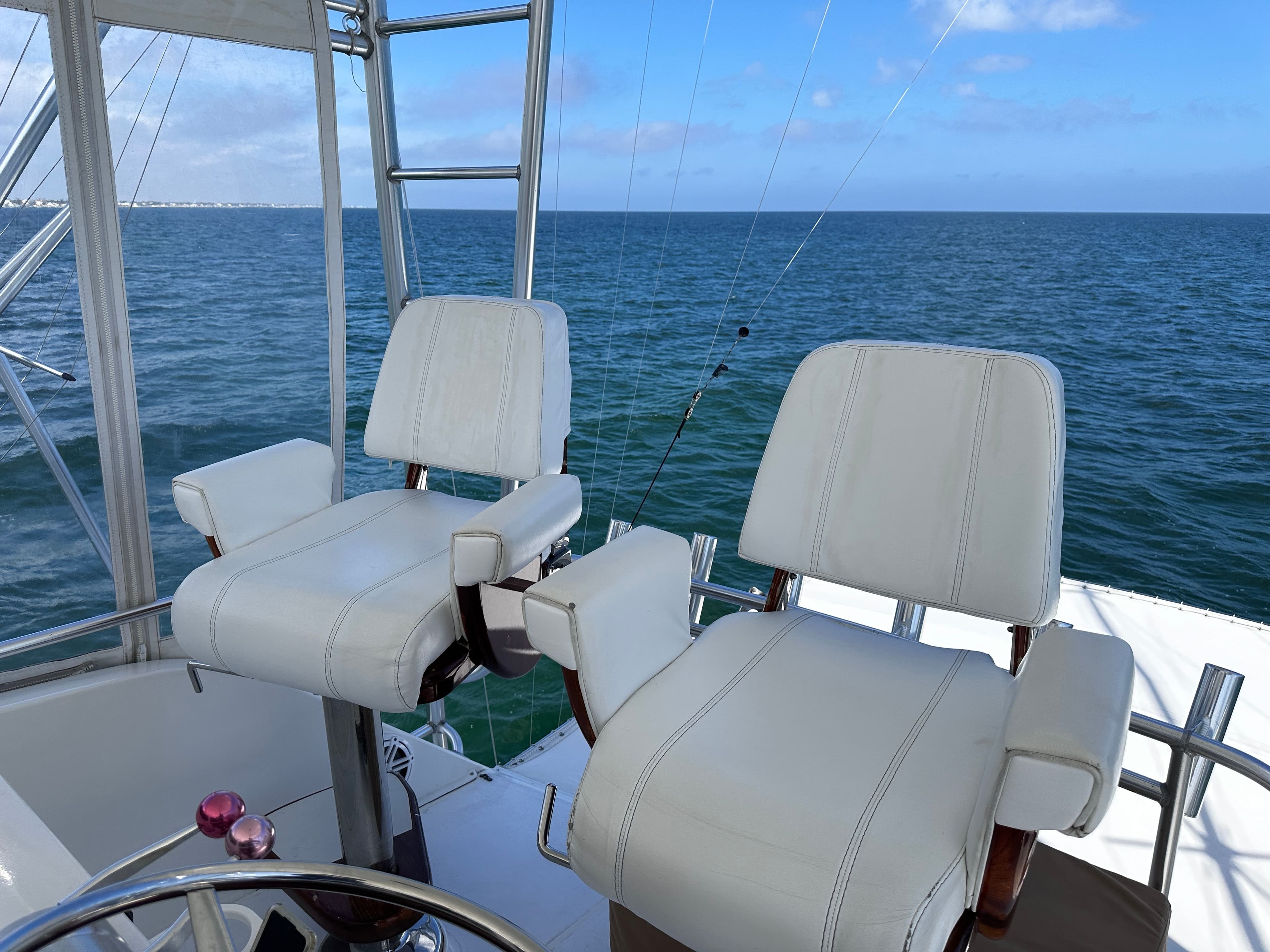 Viking 47 Convertible 1996, white seats, ocean view.