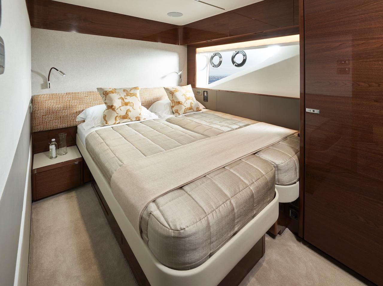 Luxurious bedroom interior of 2025 Princess X95 yacht with elegant bedding and wood accents.