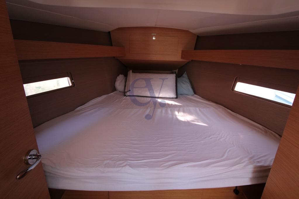 Cozy cabin interior of 2017 Dufour 382 Grand Large yacht with comfortable bedding.