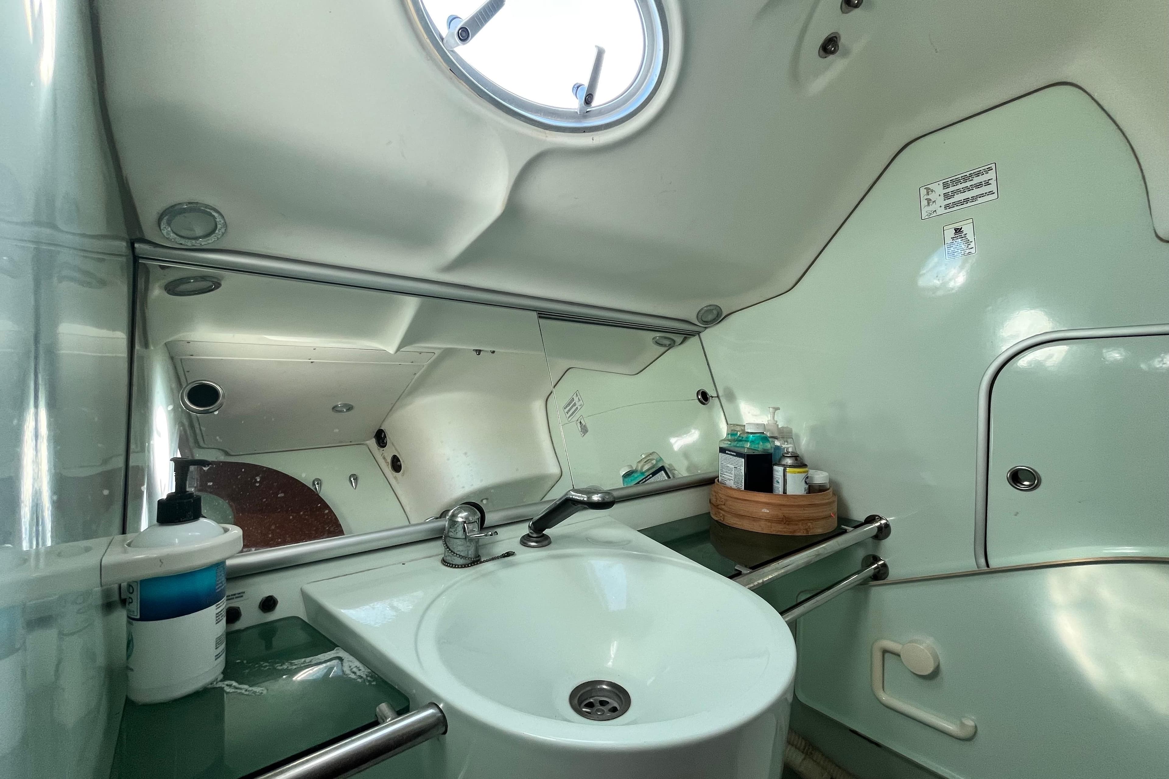 Bathroom interior of 1994 Beneteau First 35s7 yacht, featuring sink and toiletries.