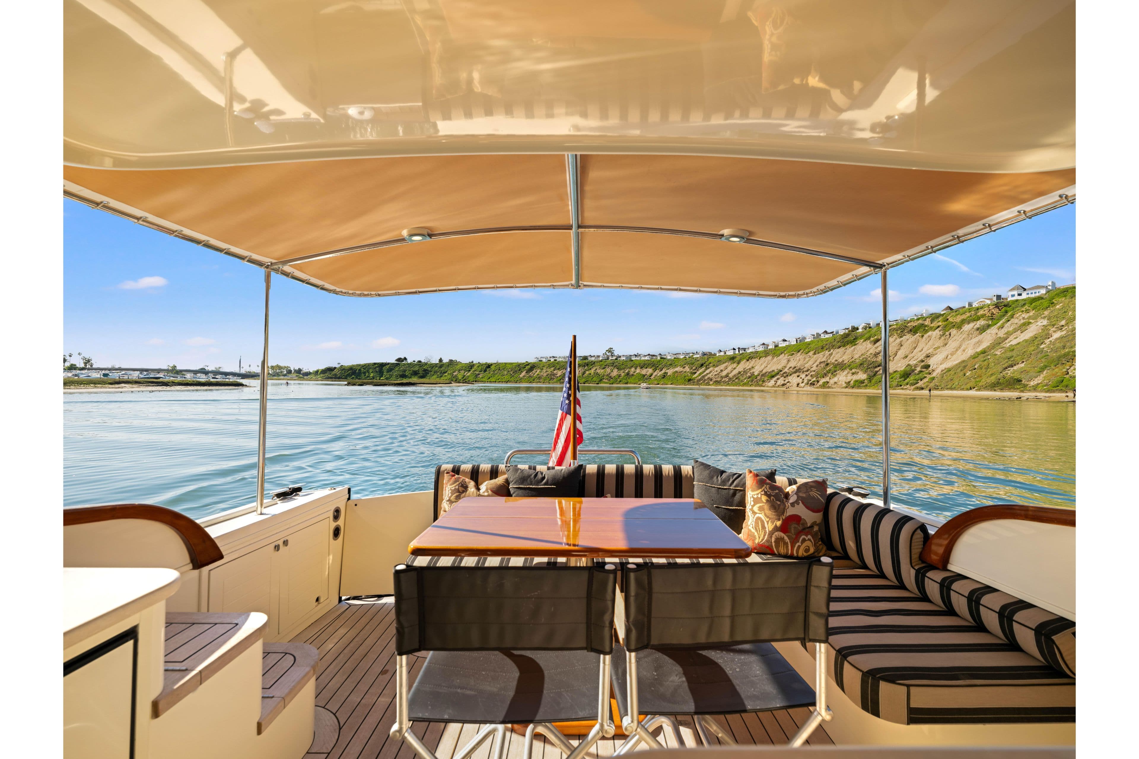 2015 Palm Beach Motor Yachts PB45 interior with elegant seating and scenic water view.