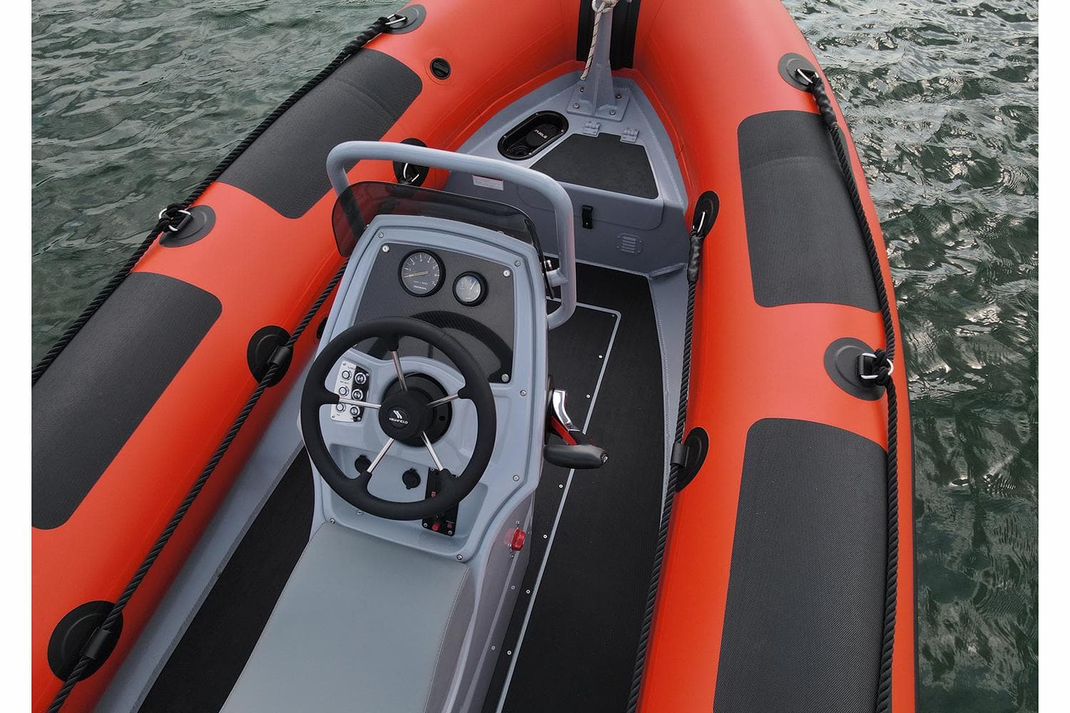2024 Highfield Patrol 420 inflatable boat with orange and black design on water.