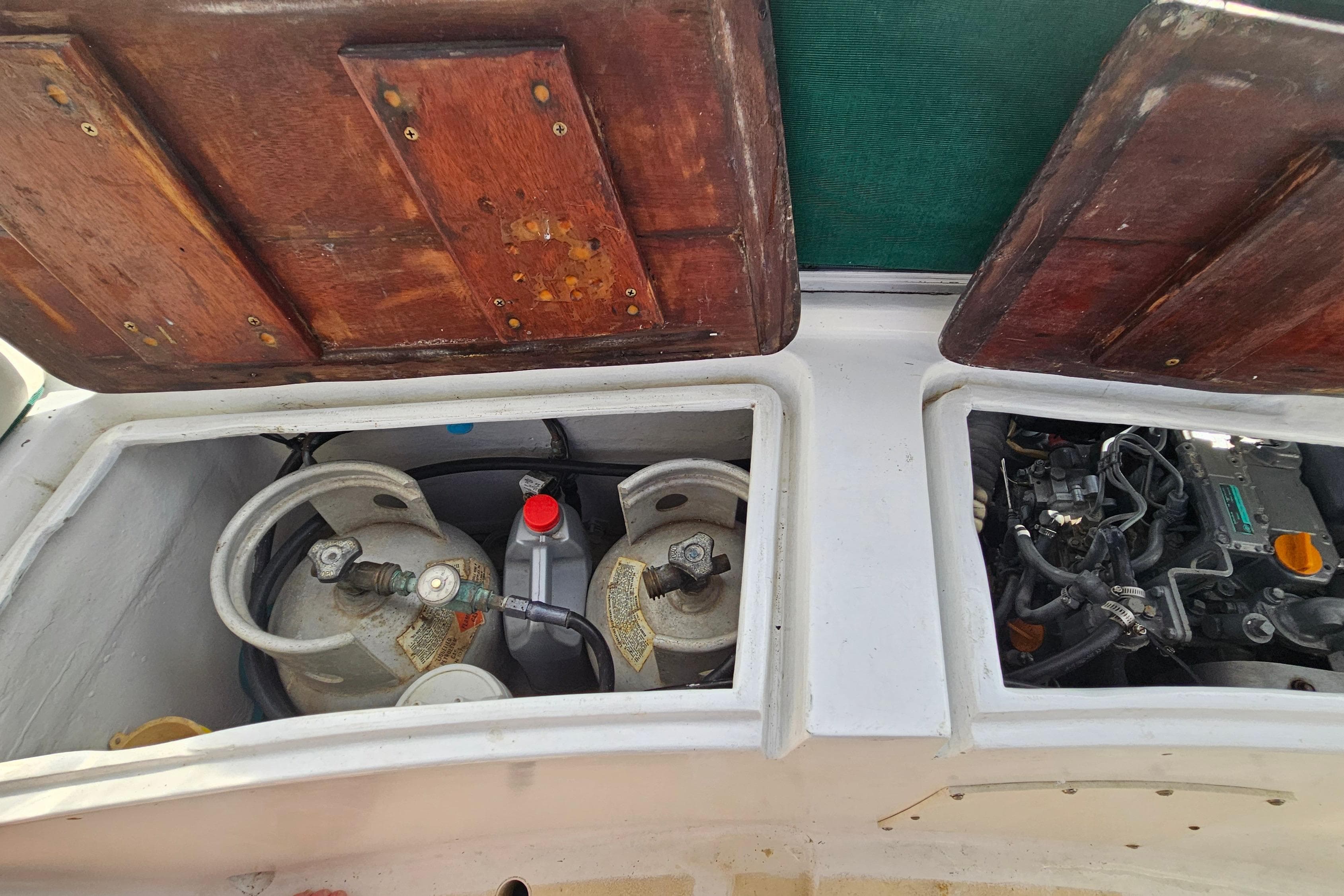1973 Prout 35 boat engine compartment with gas cylinders and mechanical components.