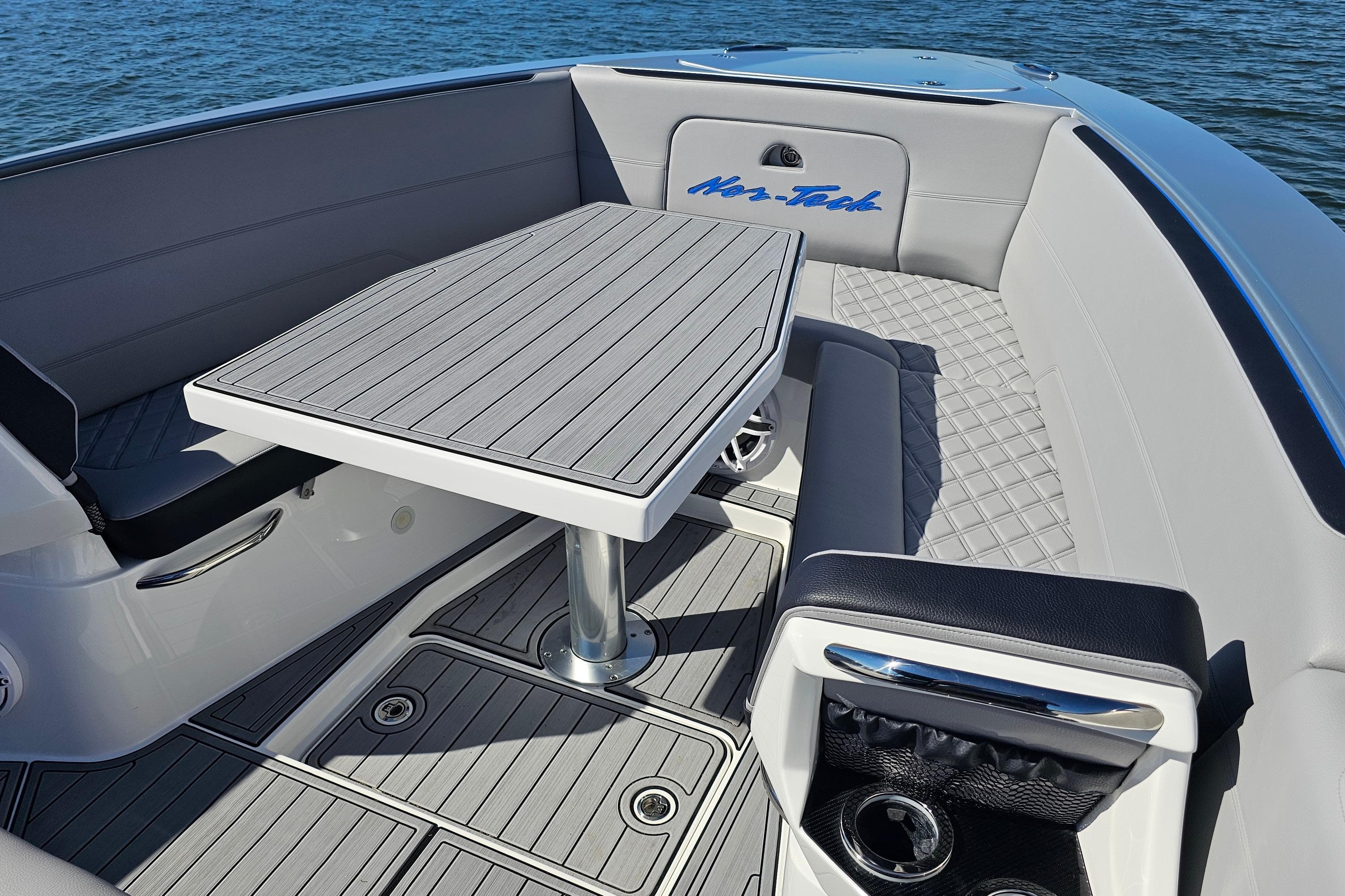 2025 Nor-Tech 390 Sport Center Console boat interior with sleek seating and table design.