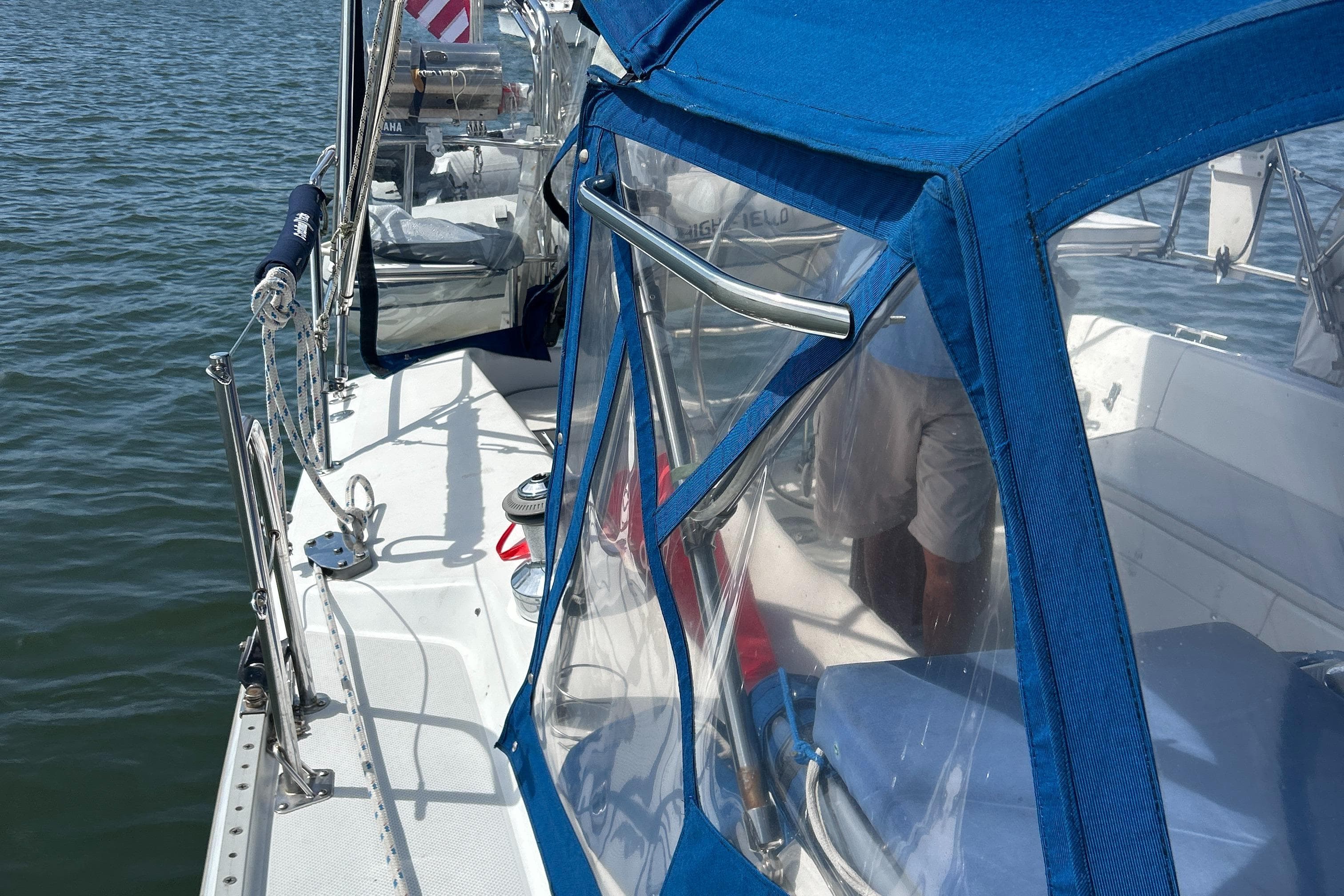 Catalina 36MKII sailboat, 1998 model, with blue canopy on calm water.