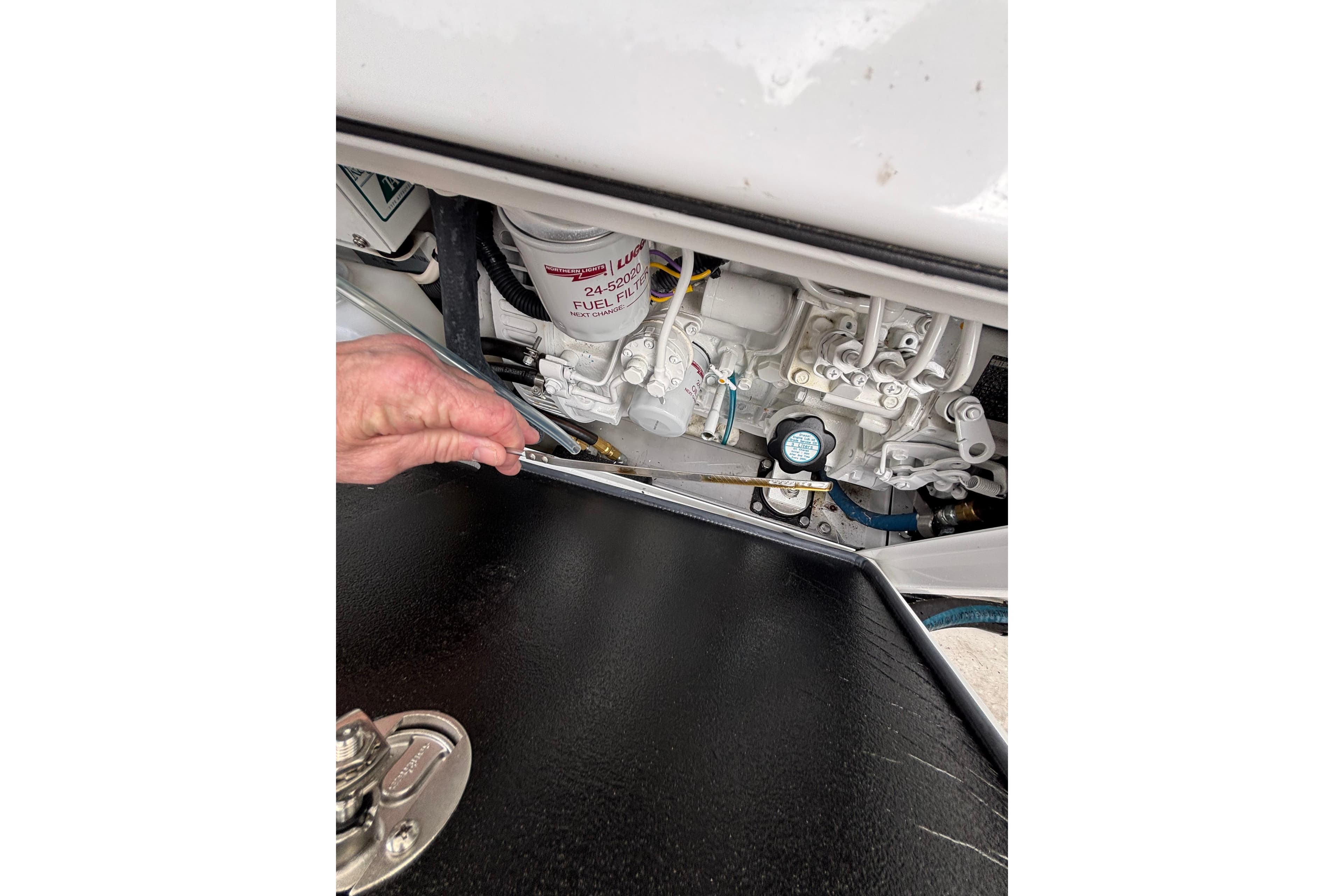 Inspecting engine components of a 2010 Boston Whaler 345 Conquest boat.