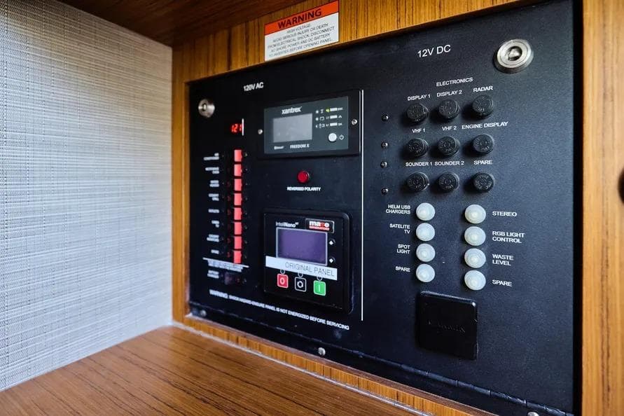 Control panel of a 2022 Solace 41 CS boat, featuring various electronic switches and displays.
