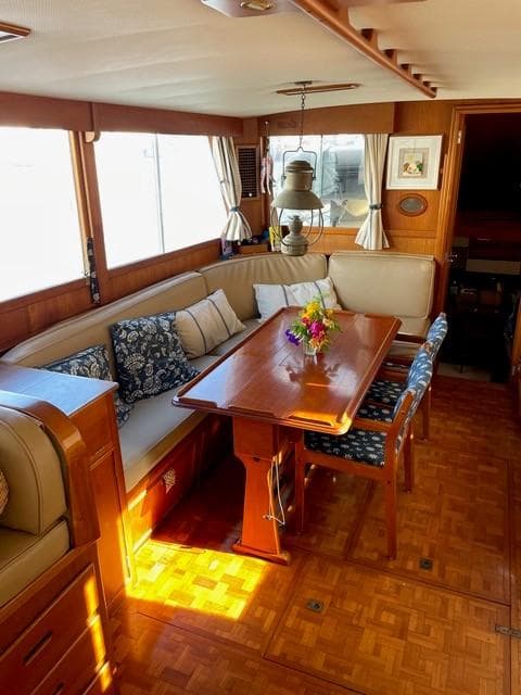 Interior of a 1986 Grand Banks 42 Classic yacht with elegant wood finish and cozy seating area.
