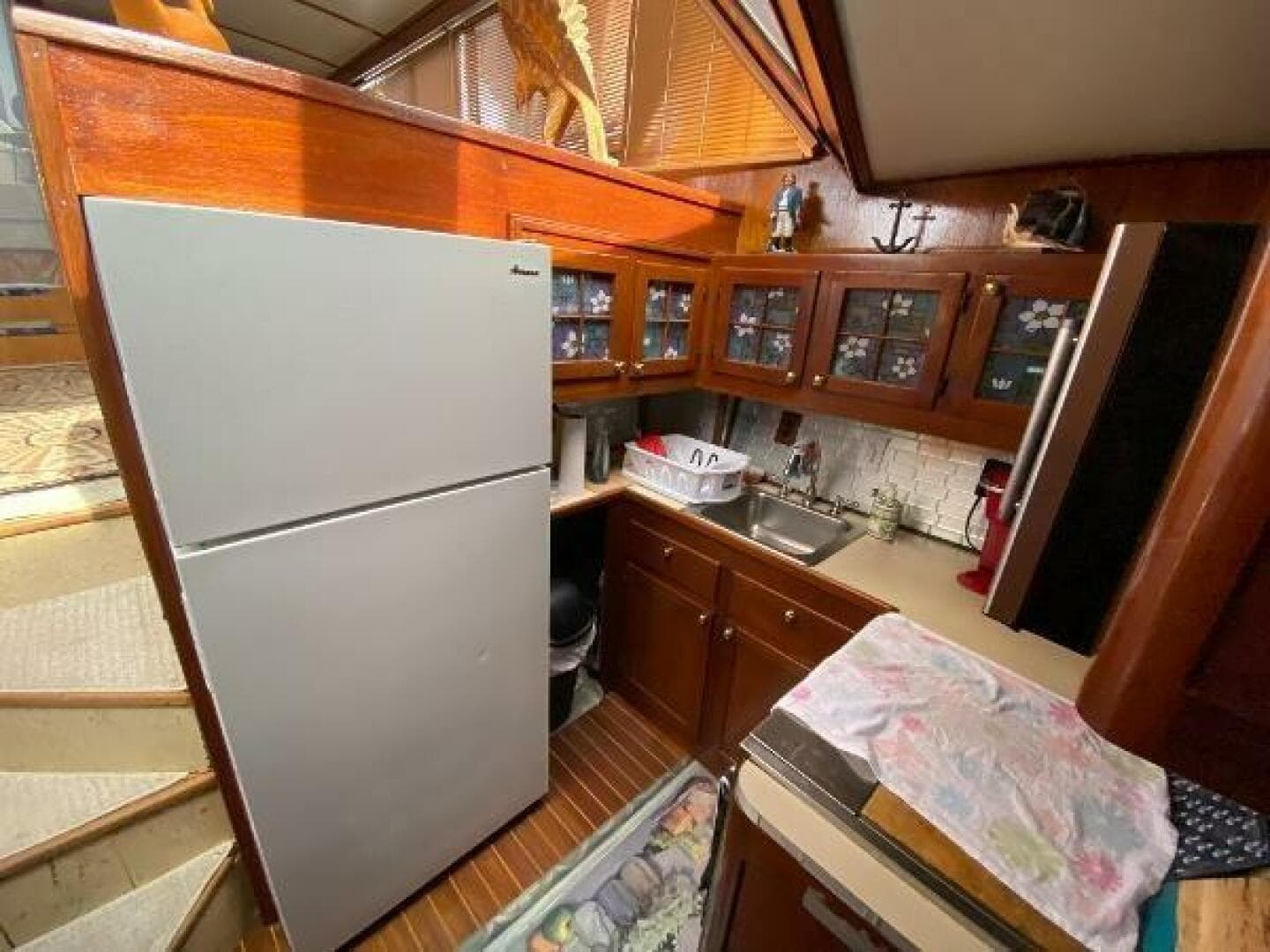 1984 Burns Craft 48 MY yacht kitchen with wooden cabinets and modern appliances.