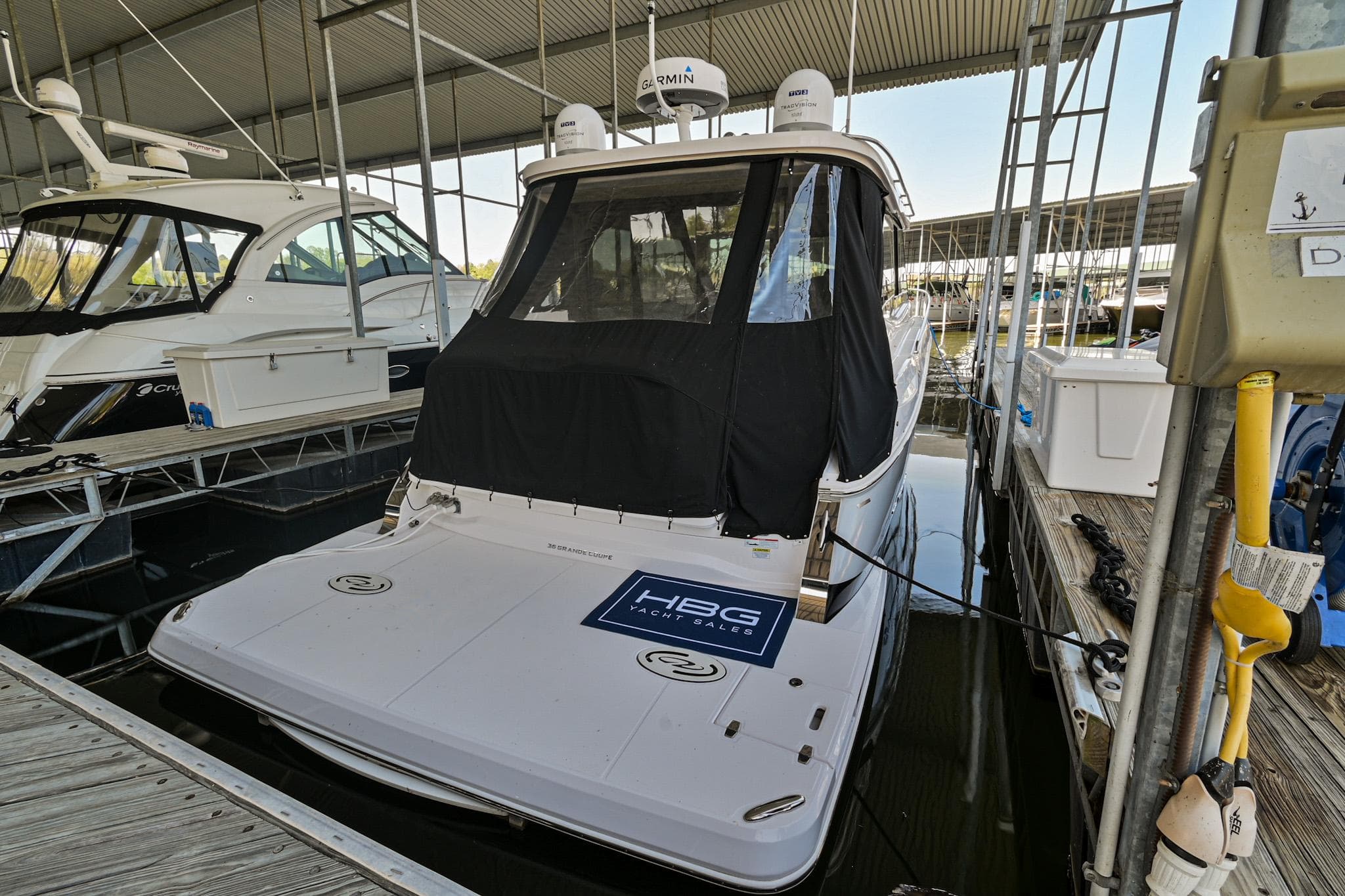 2021 Regal 36 Grande Coupe docked in a marina under a covered slip.