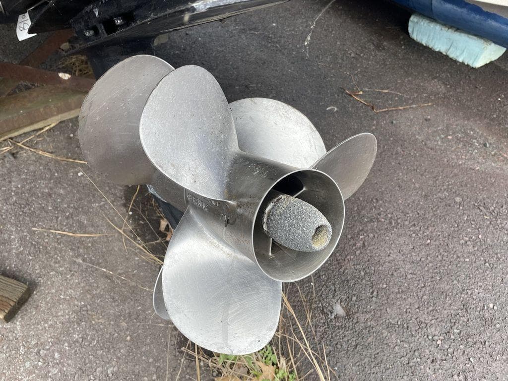 Propeller of 2007 Chaparral 250 Signature boat on asphalt surface.