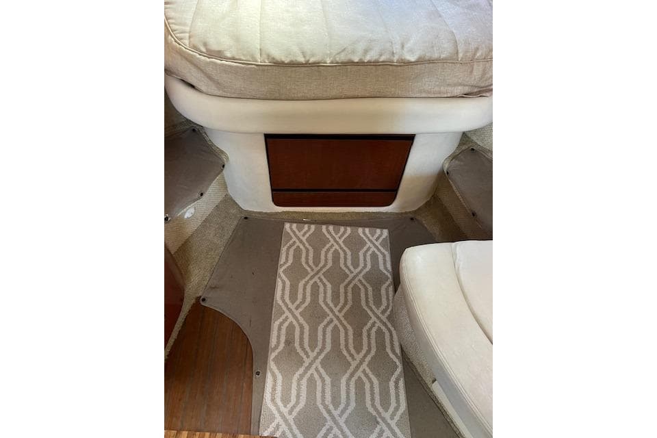 Interior of a 2005 Searay 320 boat with patterned carpet and cushioned seating.
