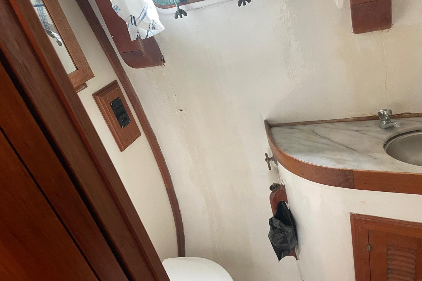 Interior of 1980 Island Trader 46 yacht bathroom with sink and wooden accents.