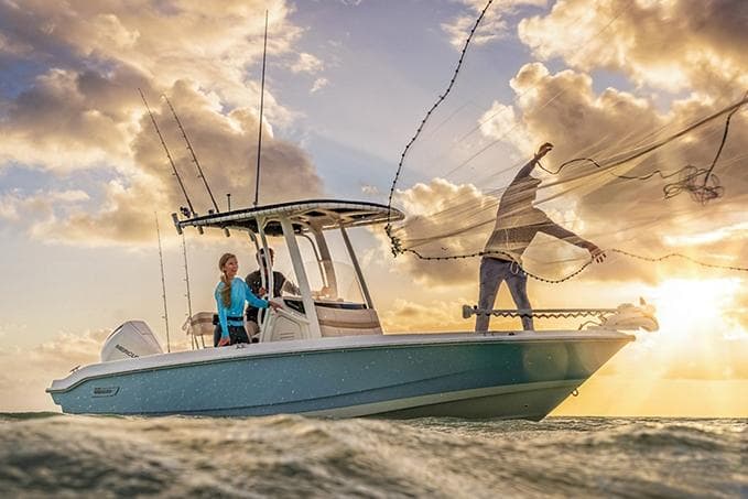 Manufacturer Provided Image: 2026 Boston Whaler 220 Dauntless boat on water at sunset, people fishing.