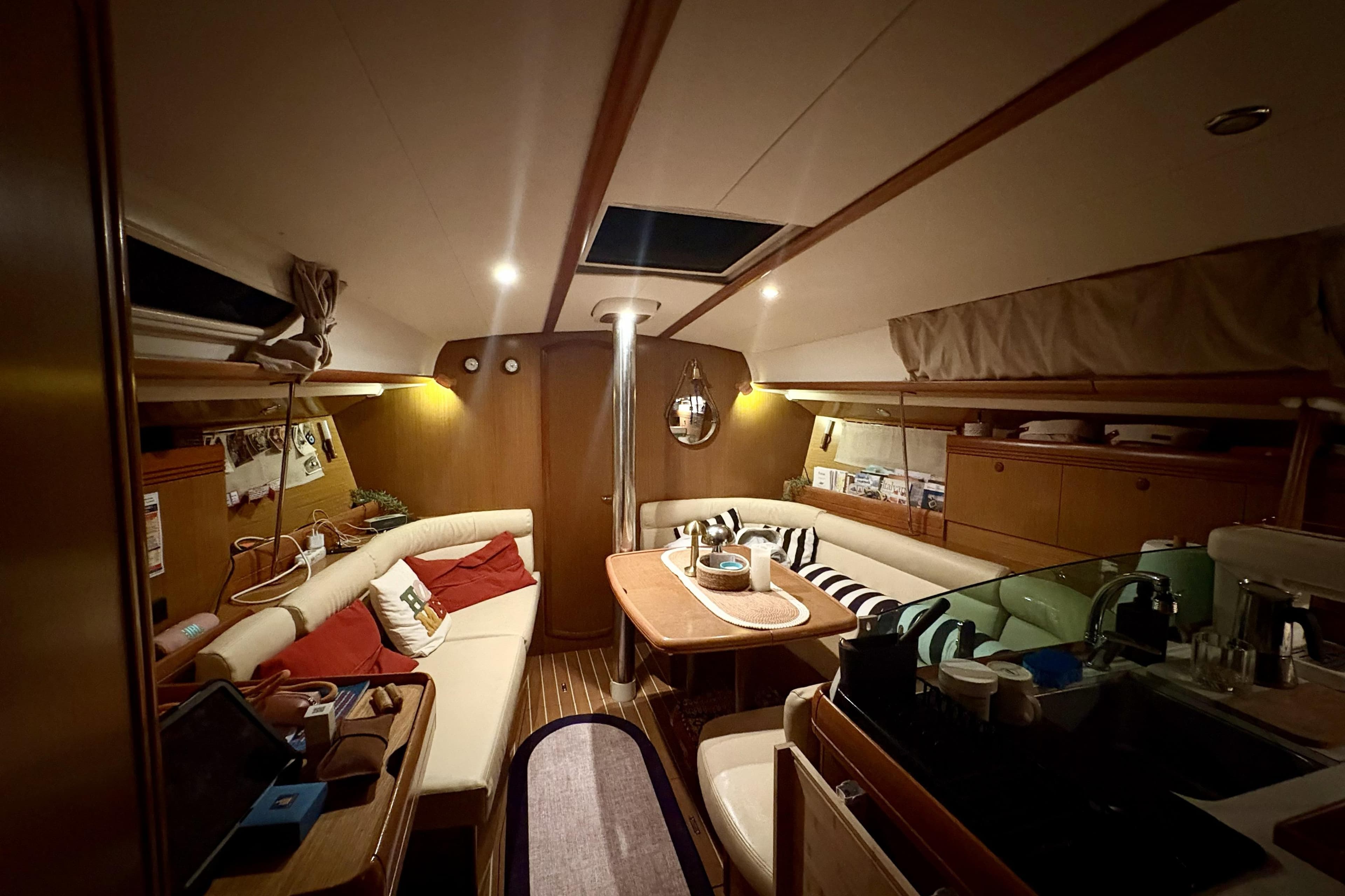 Cozy interior of 2008 Jeanneau Sun Odyssey 39i sailboat with seating and dining area.