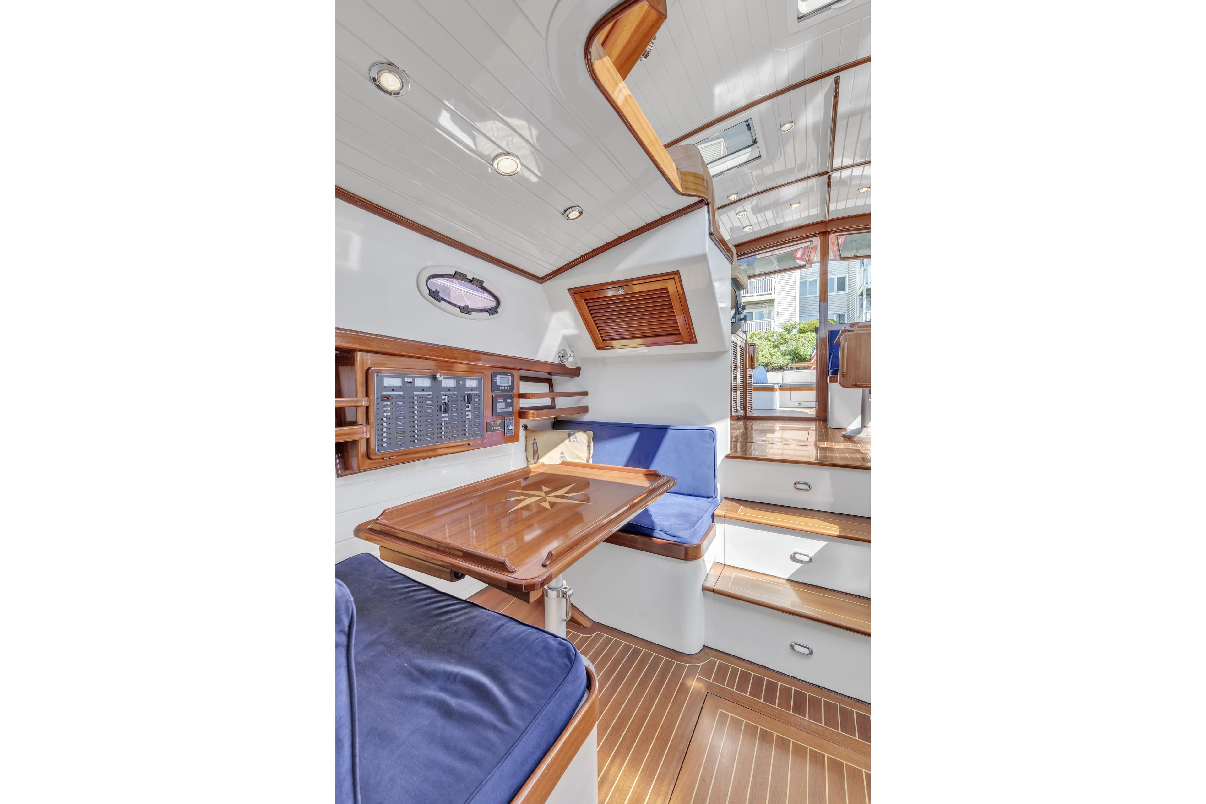 Luxurious 2007 Gorbon Custom Downeast 40 yacht interior with wood finishes and blue seating.