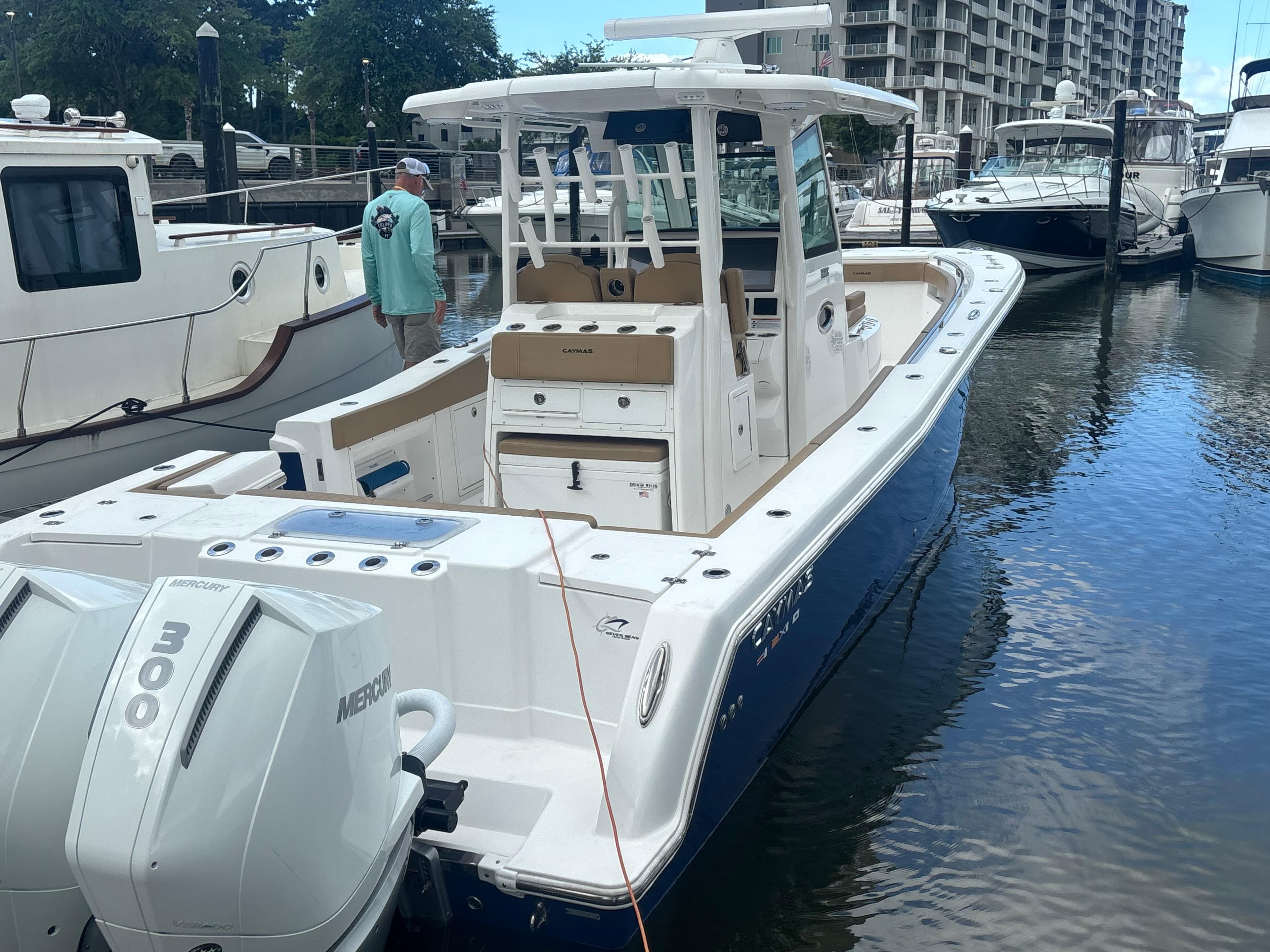 2023 Caymas 341 CC boat docked, featuring dual Mercury 300 engines.