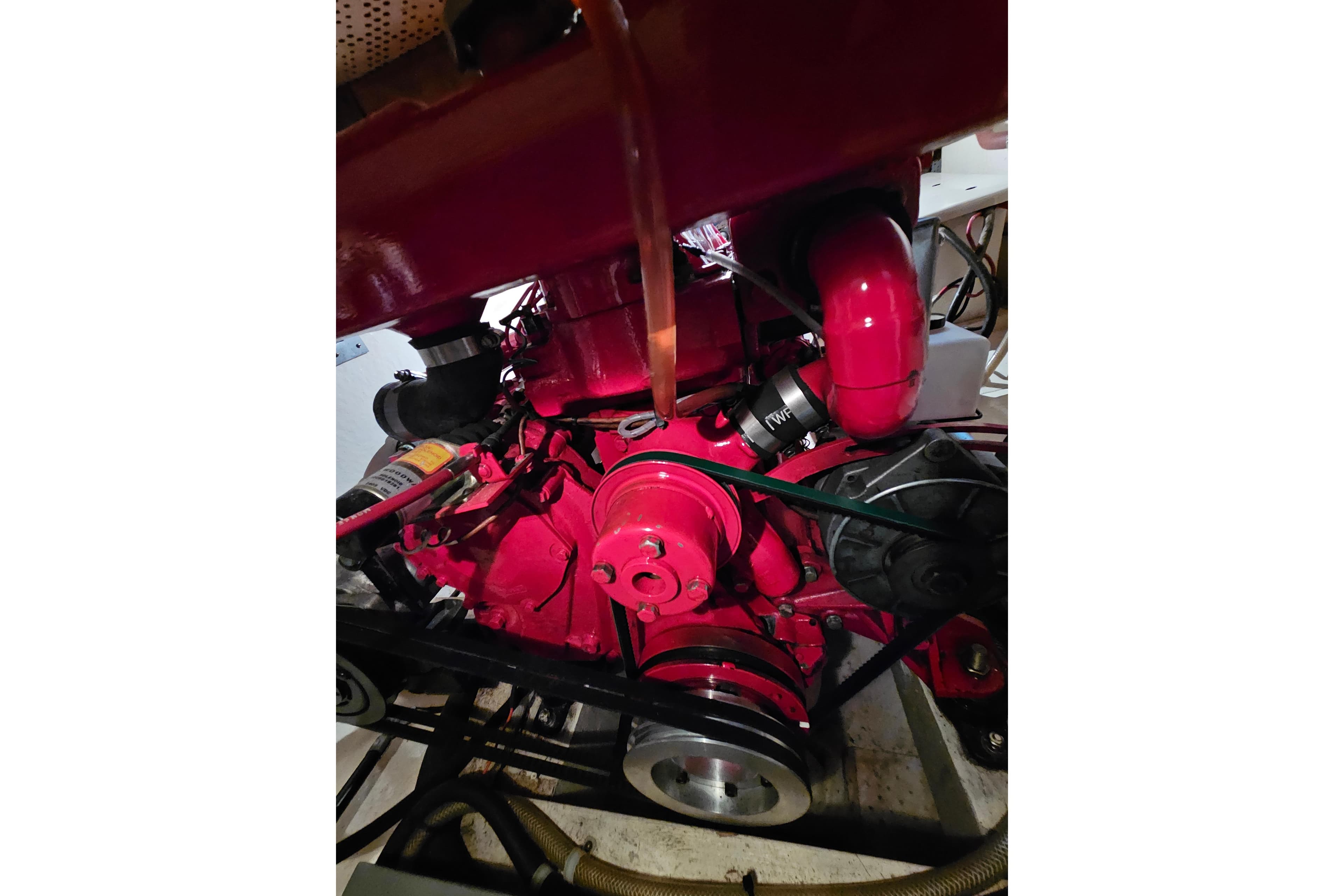 Red engine of a 1978 CHB 34 boat, showcasing mechanical components.