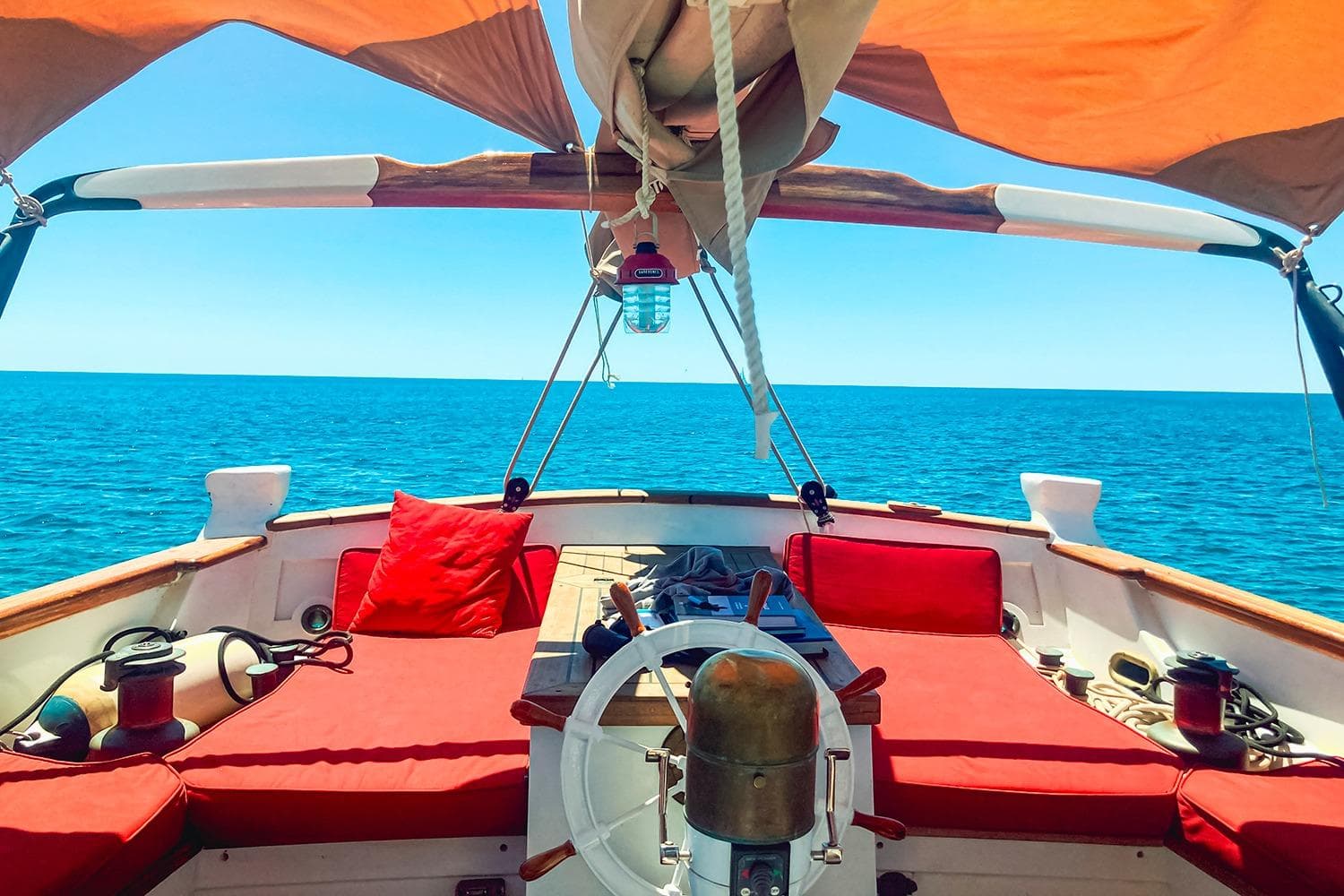 Sailing boat METUR BOMBIGHER 1996 with red cushions on open sea.