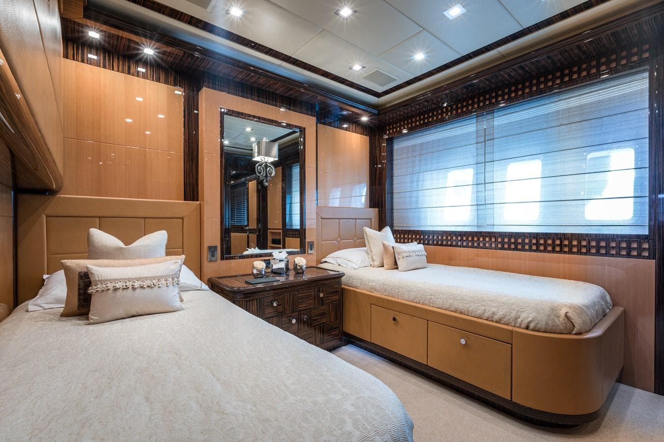 Luxurious 2011 Mangusta 165 yacht bedroom with twin beds and elegant decor.