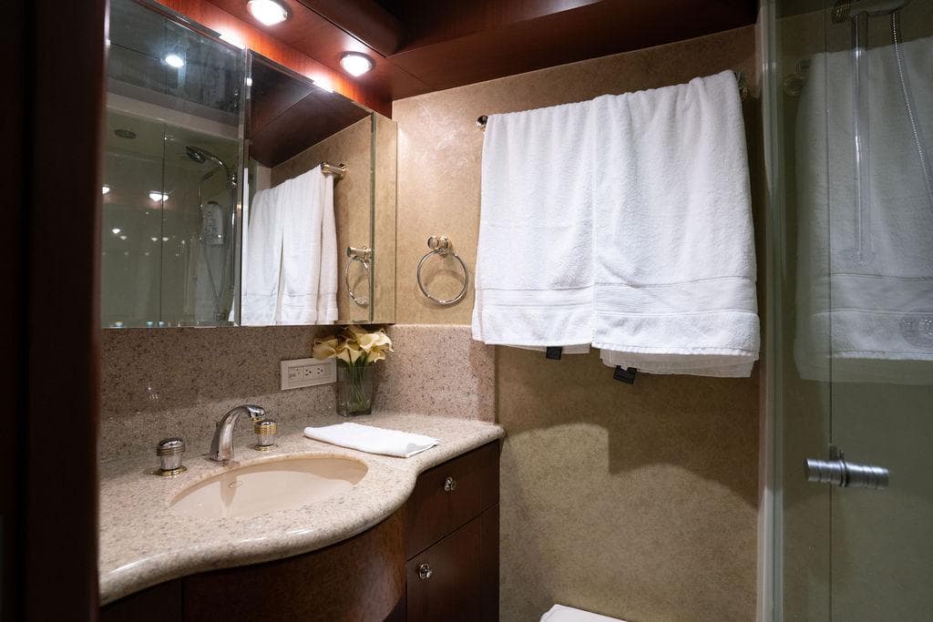 Luxurious bathroom in 2004 Cheoy Lee 84 Bravo Flybridge yacht with elegant fixtures.