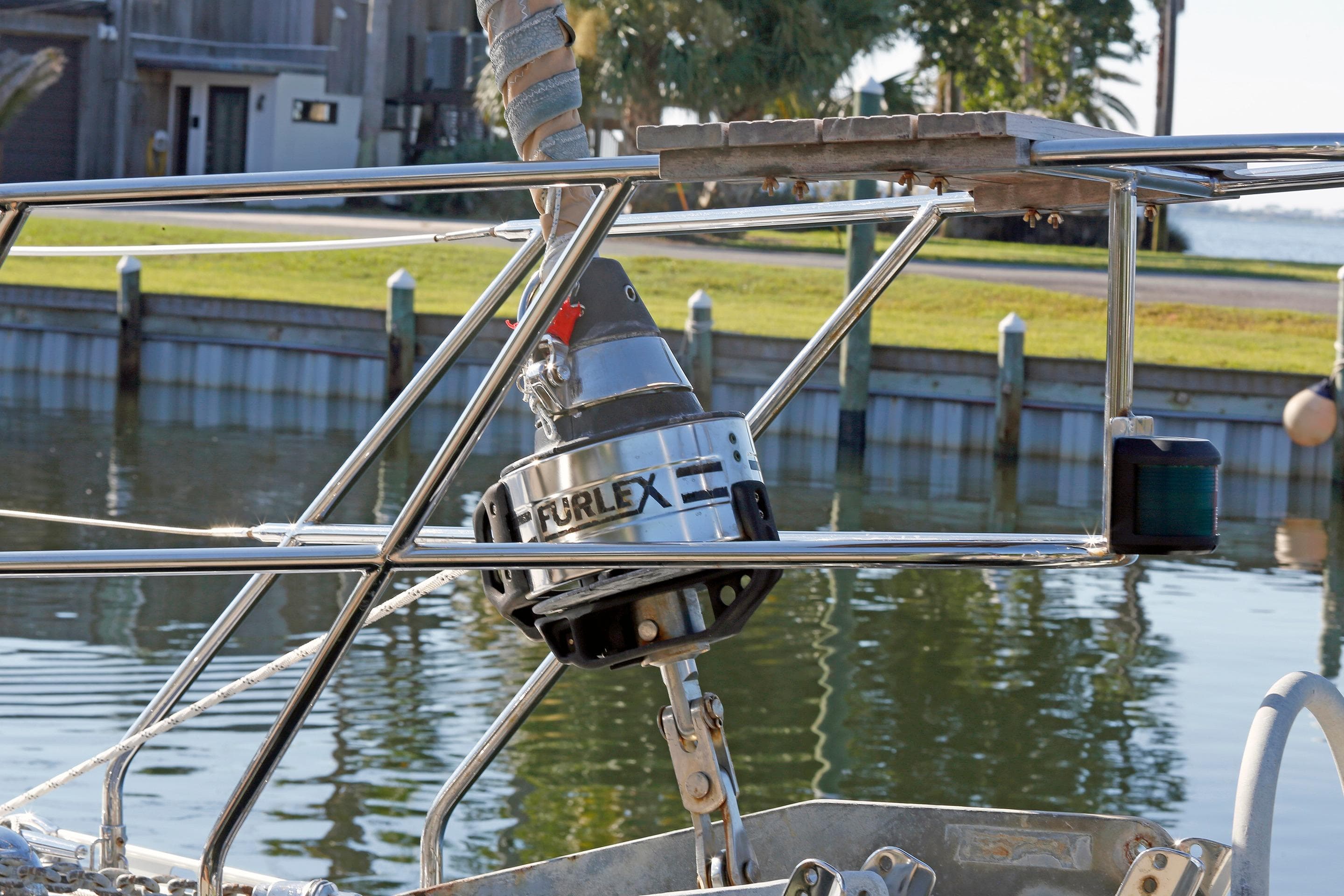 Stainless steel furling system on a 2012 Hylas 49CC sailboat by the water.