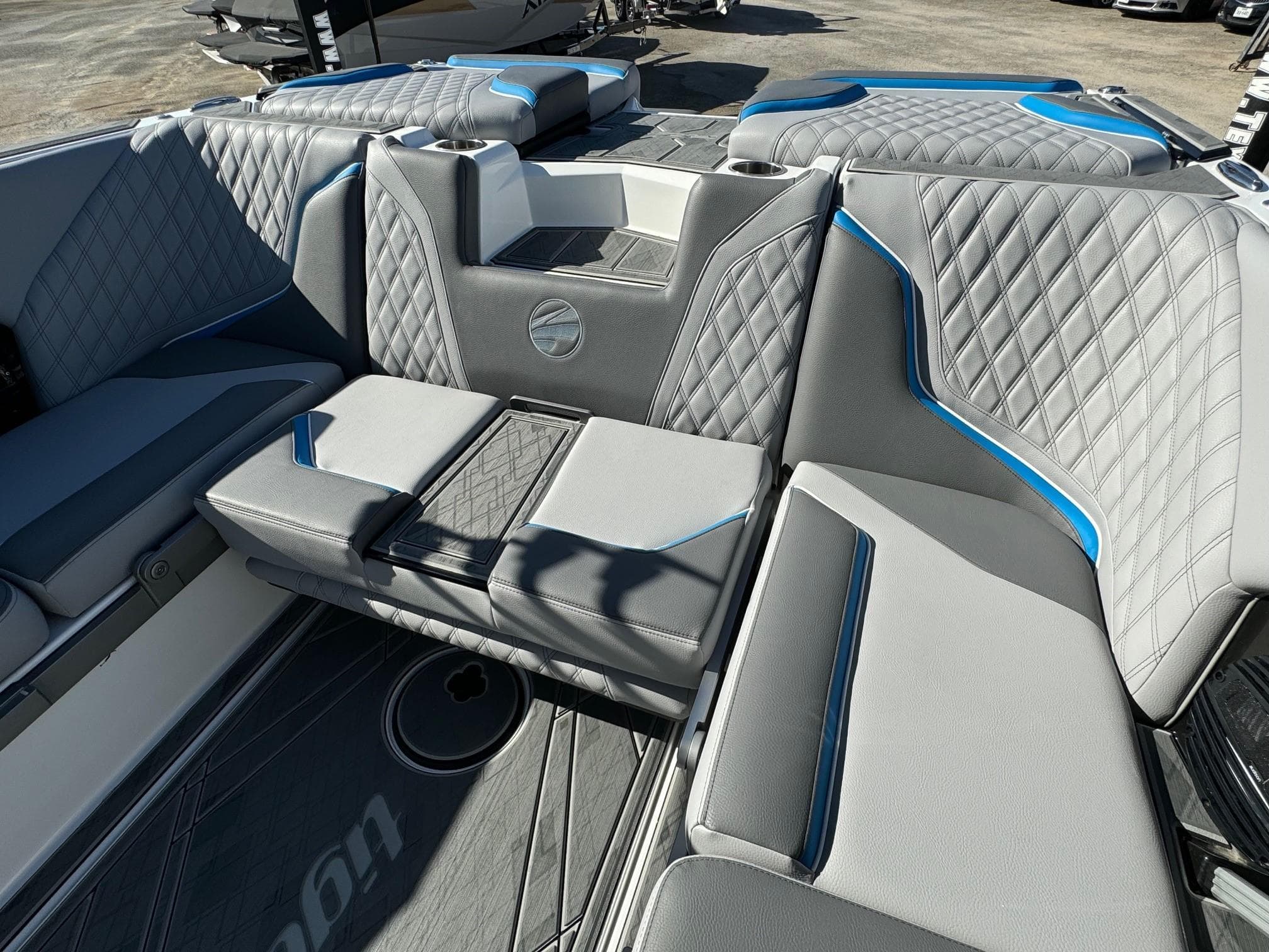 2025 Tigé 24RZX boat interior with gray and blue diamond-stitched seating.
