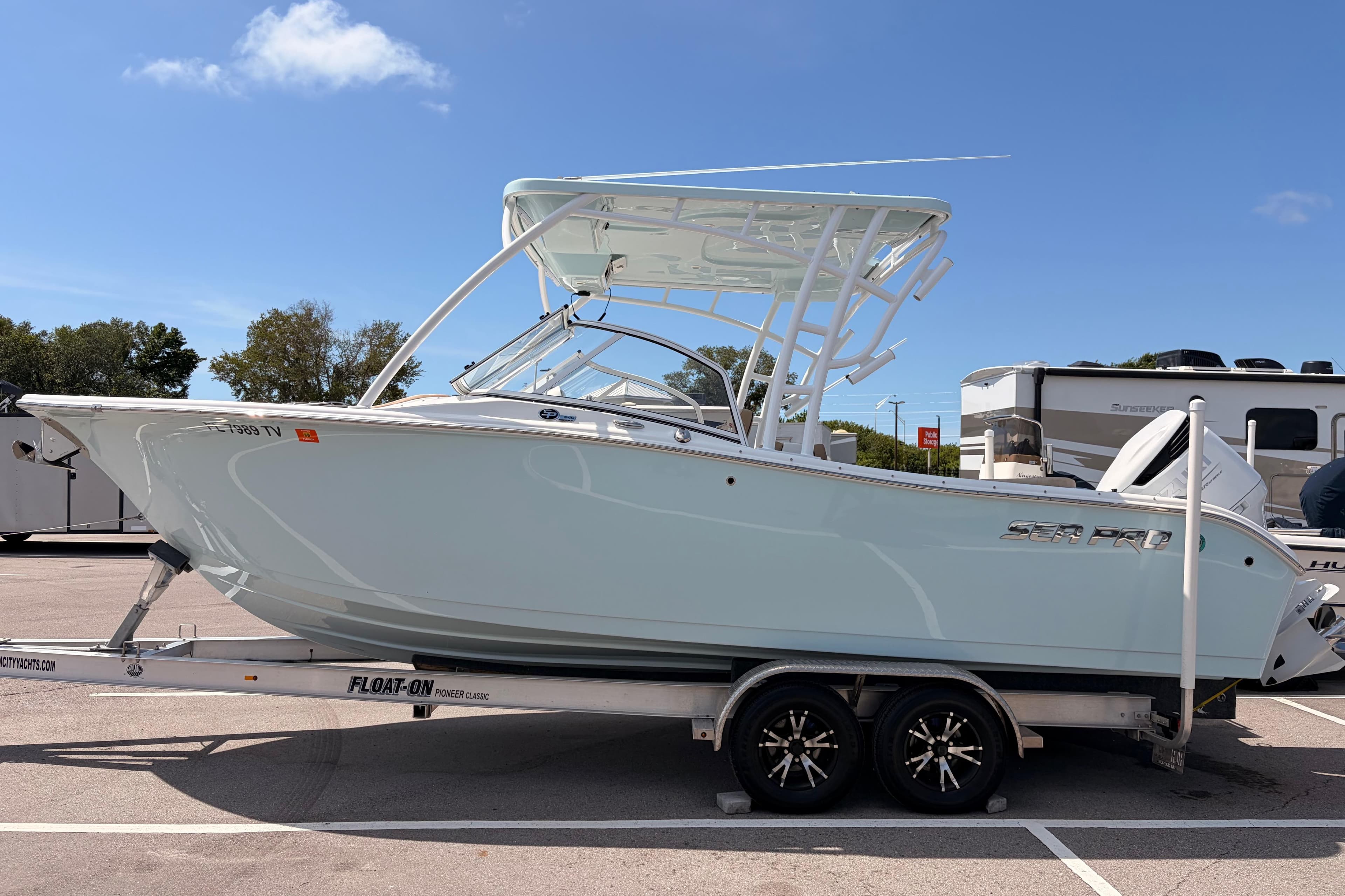 2025 Sea Pro 240 Dual Console boat on trailer under clear blue sky.