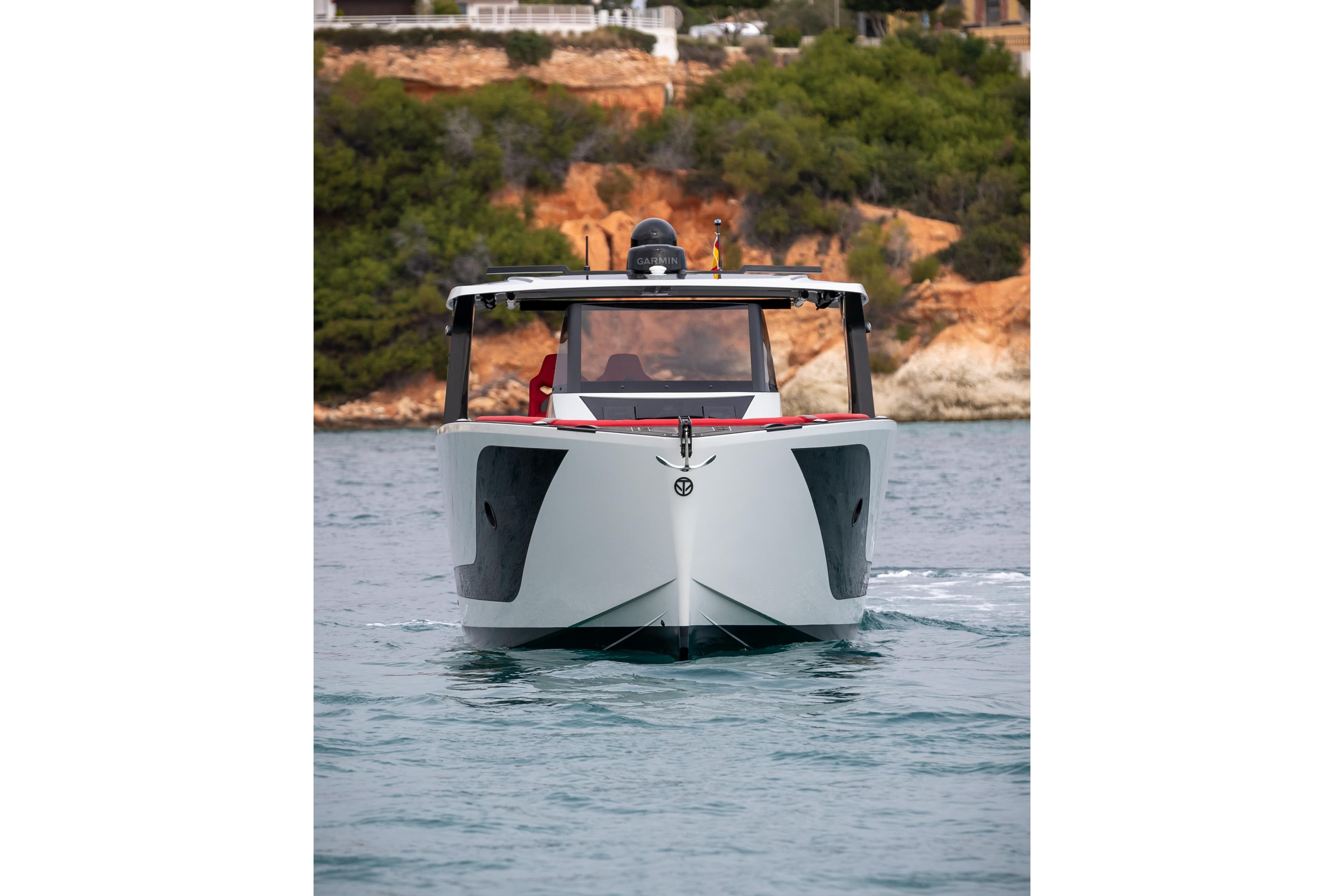 Tesoro 40 GTS 2026 yacht on water with coastal backdrop.