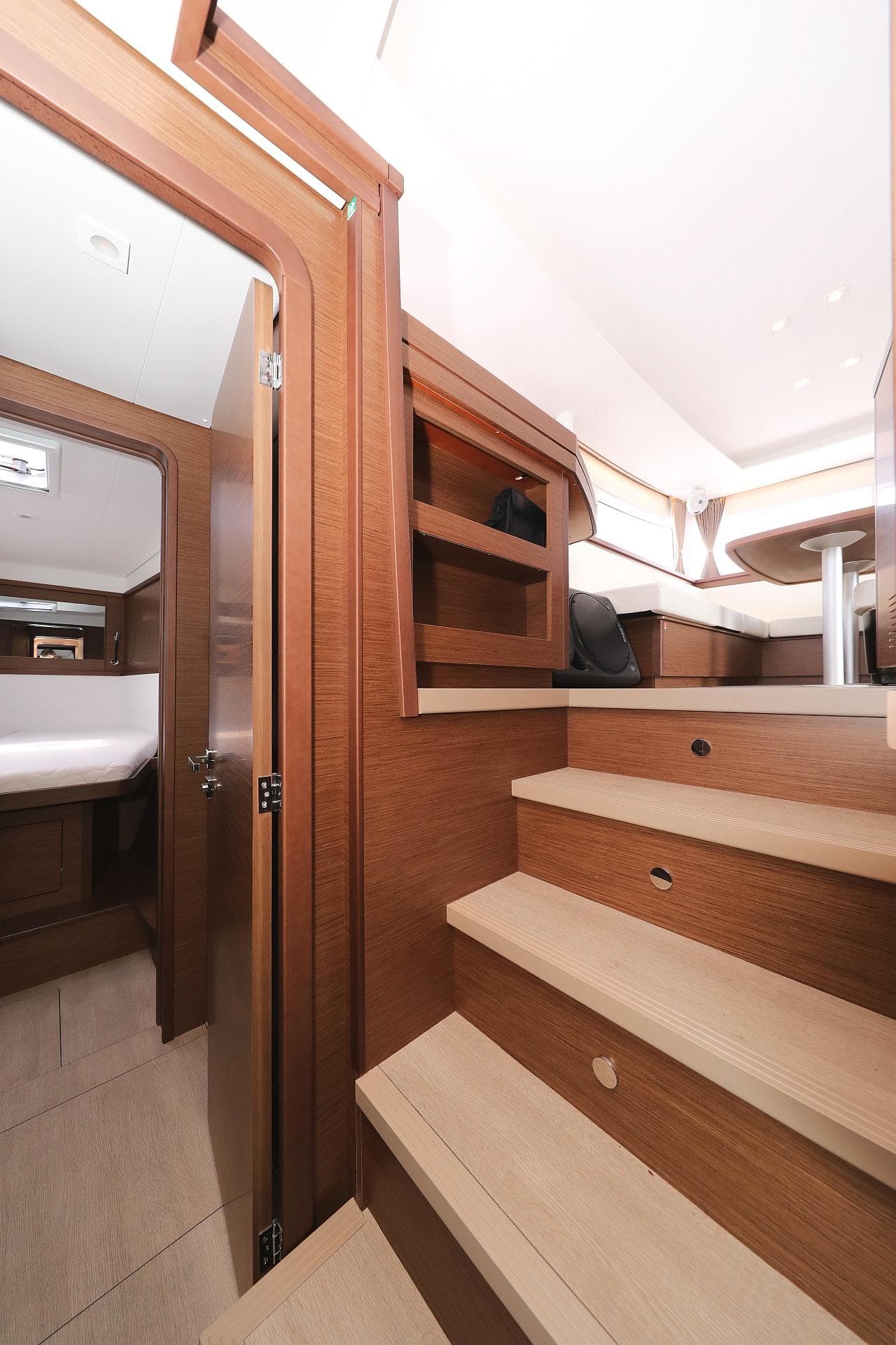 Interior of 2019 Lagoon 450S yacht with wooden stairs and cozy cabin.