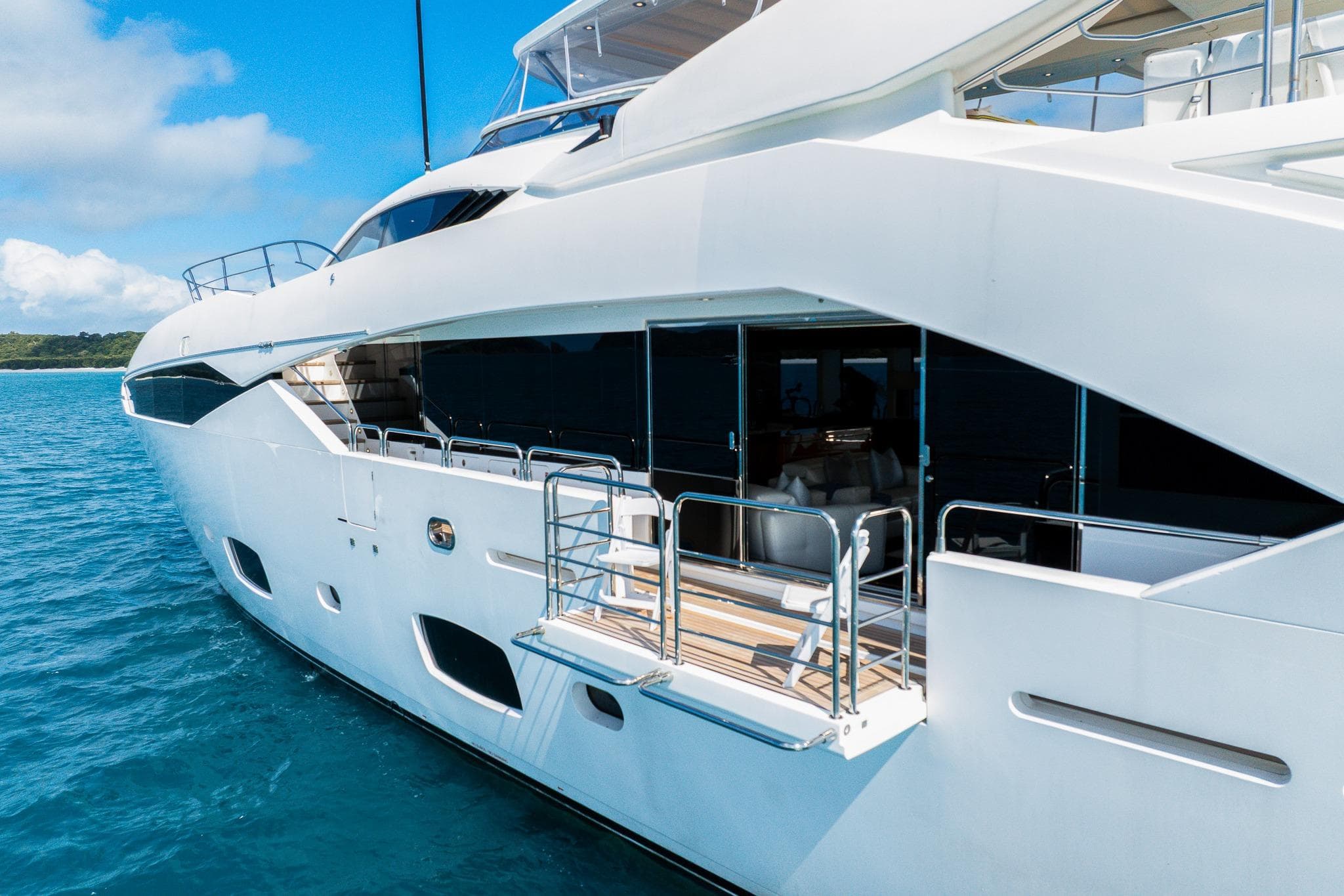 2015 Sunseeker 115 Sport Yacht on blue ocean, showcasing sleek design and luxury features.