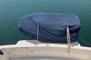 2001 Bayliner 3988 Motoryacht with covered equipment on deck, docked on calm water.