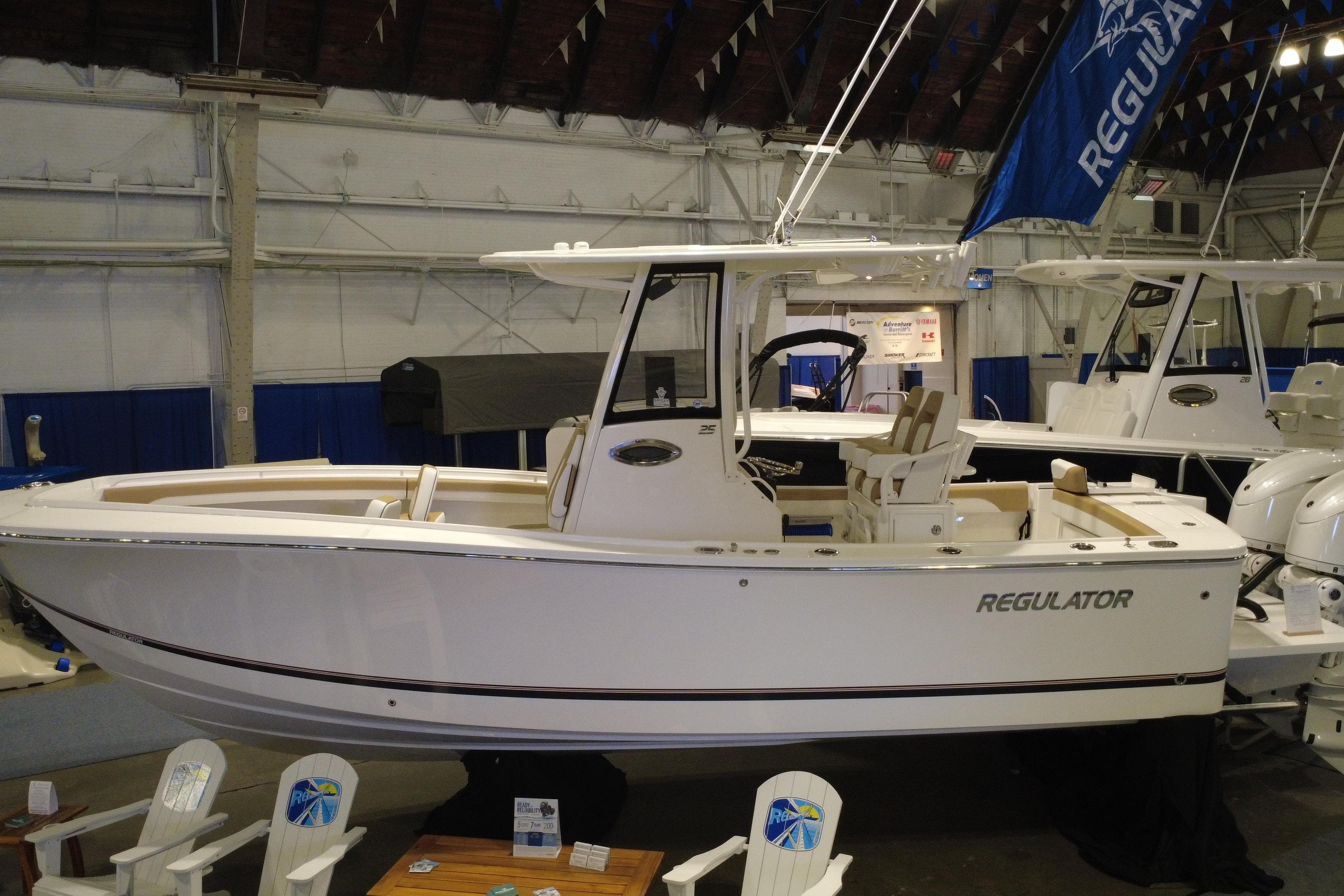 2025 Regulator 25 boat displayed indoors at a boat show.