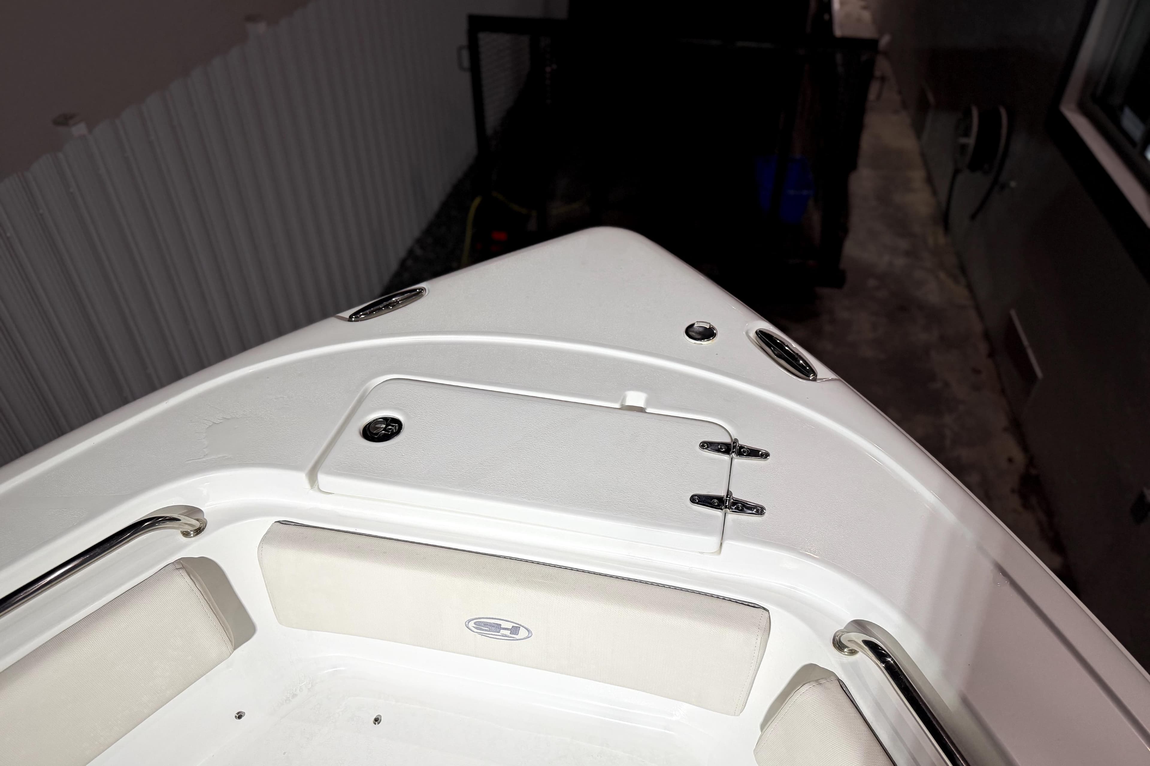 2024 Sea Hunt Ultra 239 SE boat bow with storage compartment and seating.