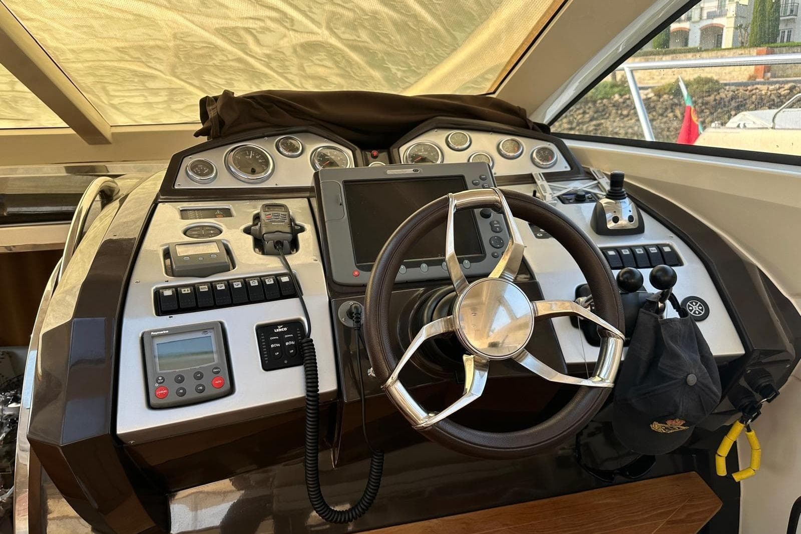 Control panel of a 2007 Absolute 56 yacht with steering wheel and navigation instruments.
