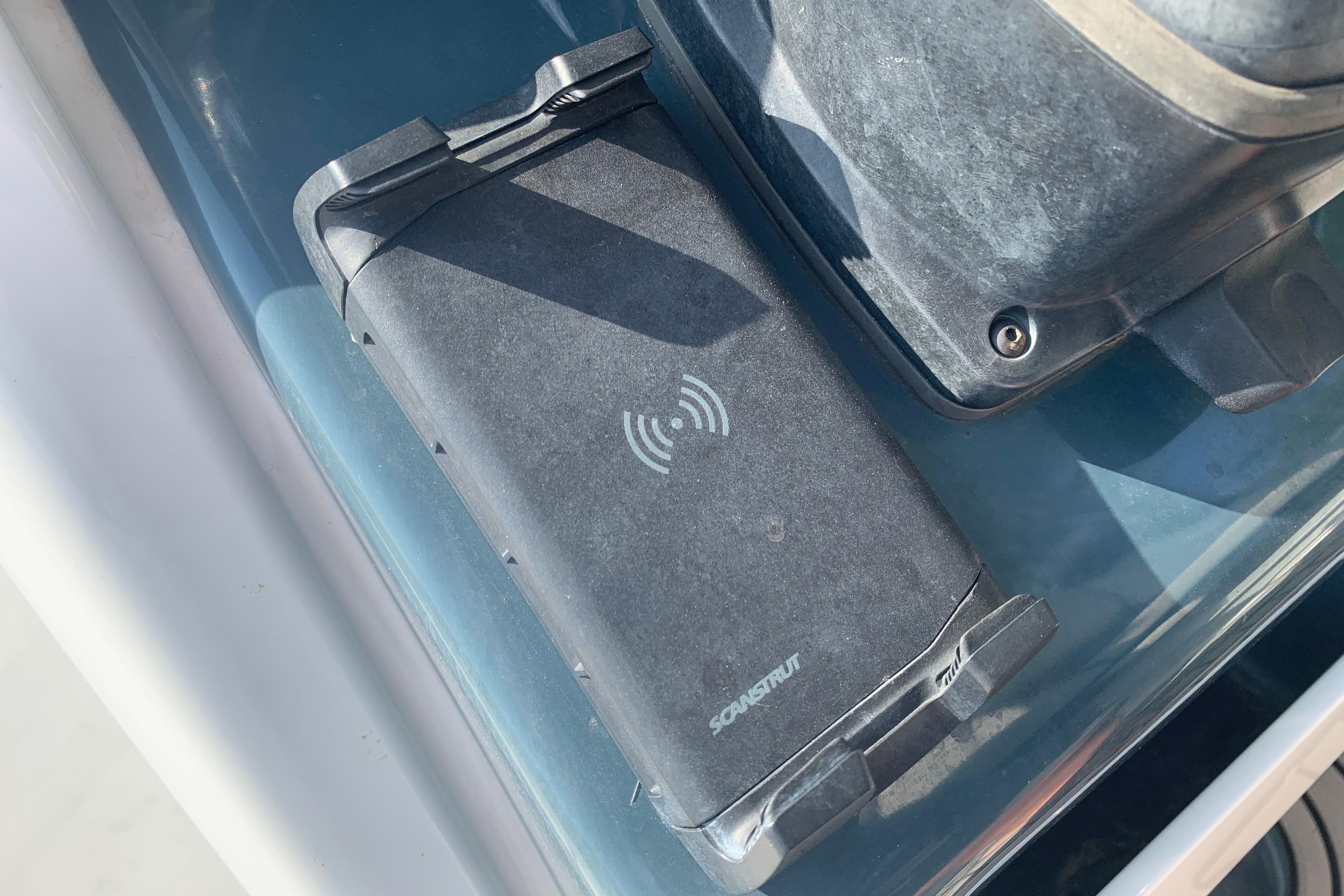 Wireless charging pad on 2021 Tidewater 256 CC Adventure boat dashboard.