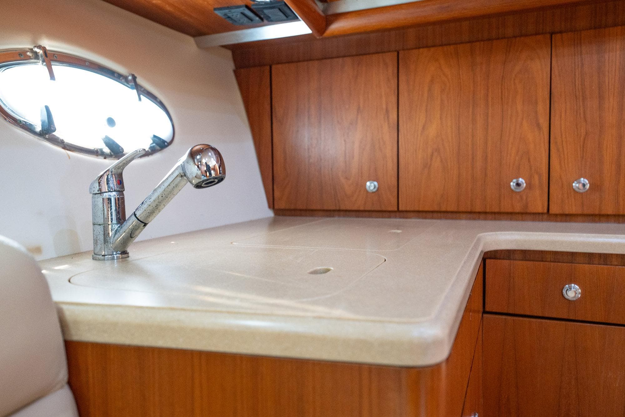 2004 Tiara Yachts 4200 Open interior with wooden cabinets and modern sink.