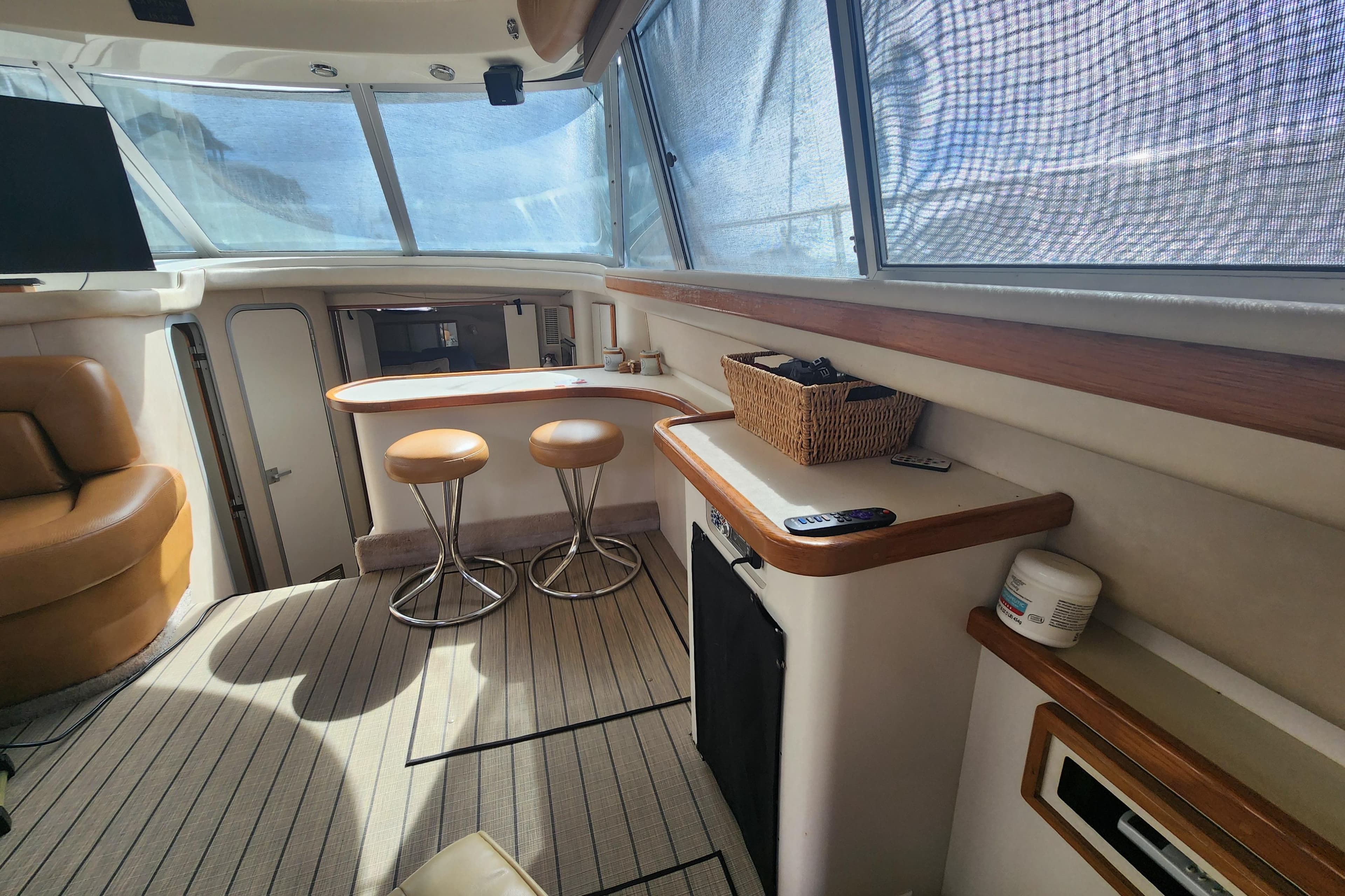 Interior of 1996 Sea Ray 370 Sedan Bridge with seating and bar area.