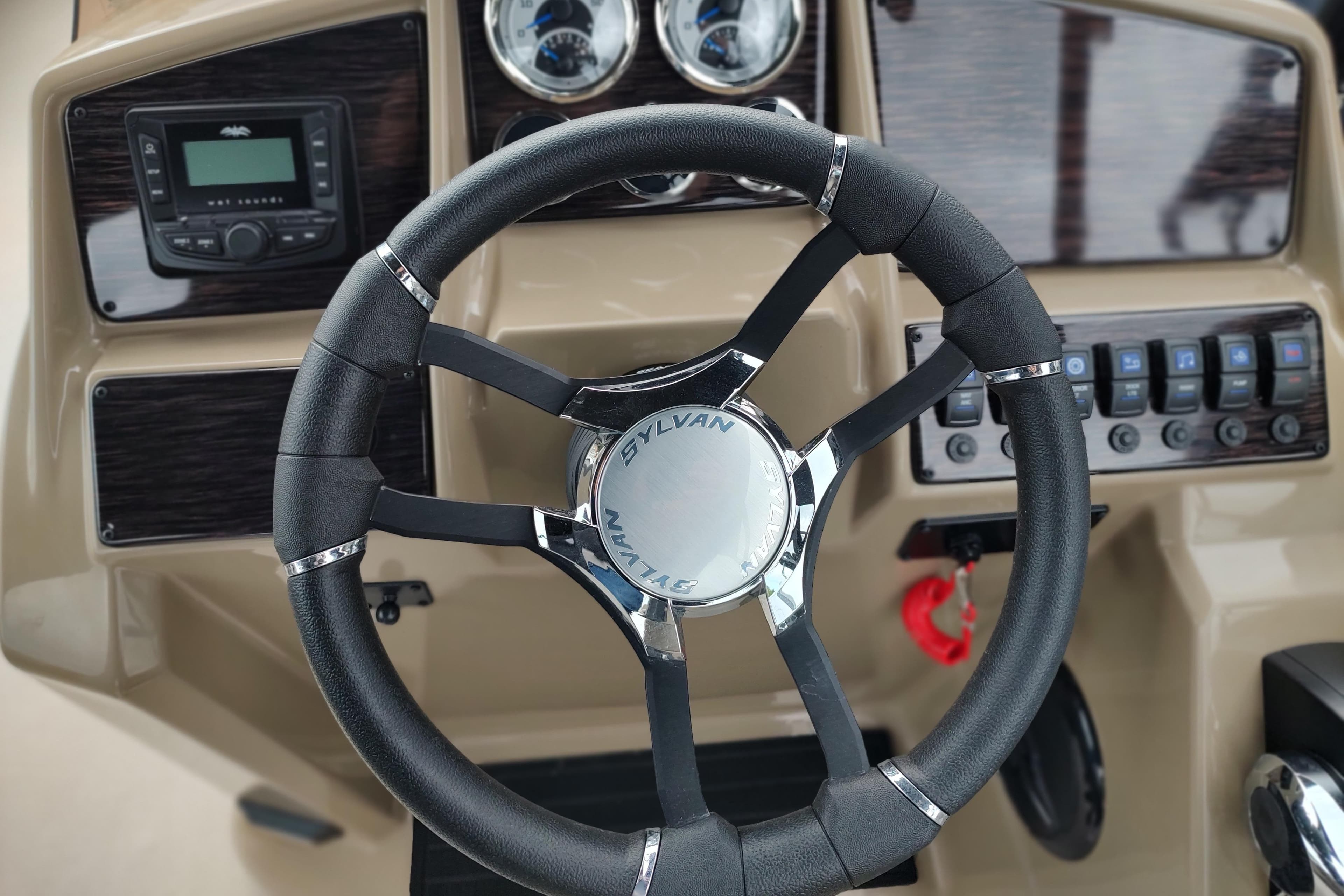 Steering wheel of 2026 Sylvan Mirage X3 Party Fish boat with dashboard controls.