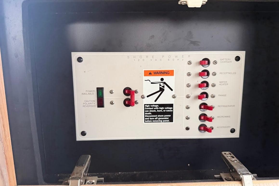 Electrical panel on a 2001 Bayliner 3258 Command Bridge boat with warning label.